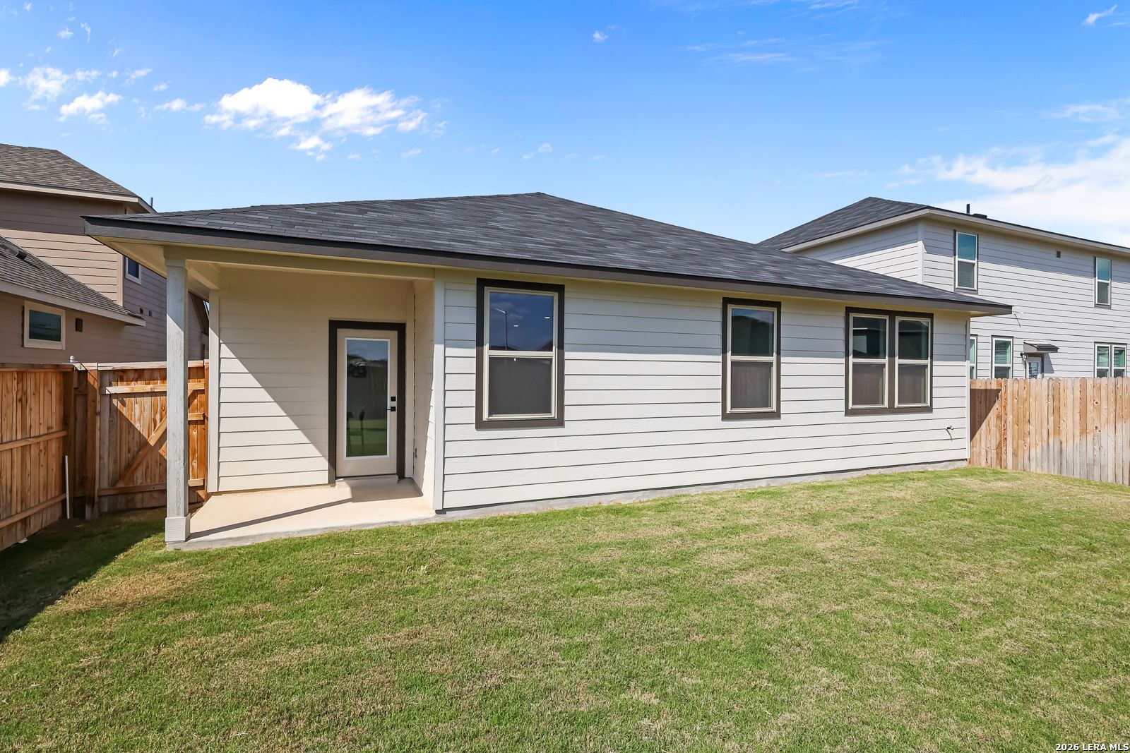 Side view of single-story 3-bedroom Davidson Homes Daphne H with covered porch, fenced yard, and garage in Hannah Heights, Seguin, Texas