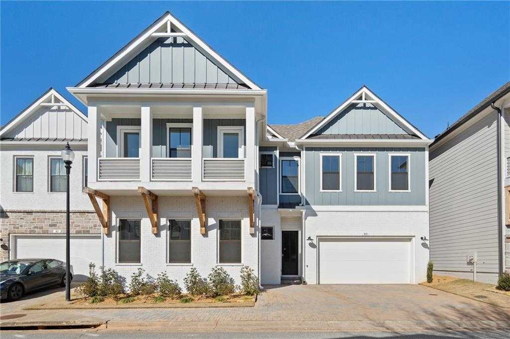 Modern 2-story Seaside A home by Davidson Homes with balcony, 3-car garage, and stone accents in The Village at Towne Lake, Woodstock, Georgia