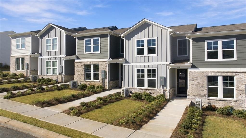 Modern two-story homes with gray siding and brick accents at Stegall Village, Emerson Georgia by Davidson Homes