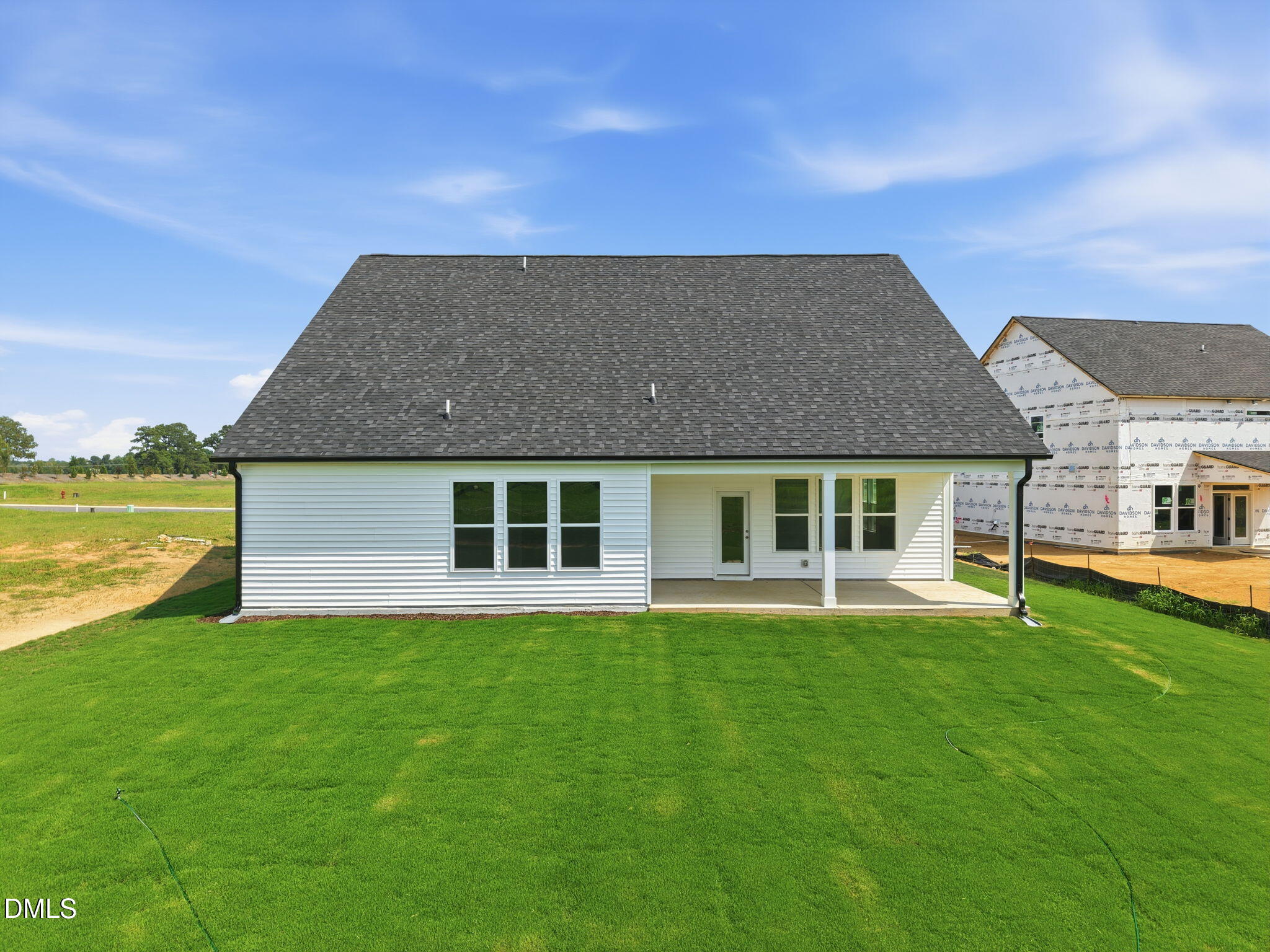 Back exterior of The Magnolia B floor plan by Davidson Homes featuring a covered patio at Retreat at North Main, Lillington.