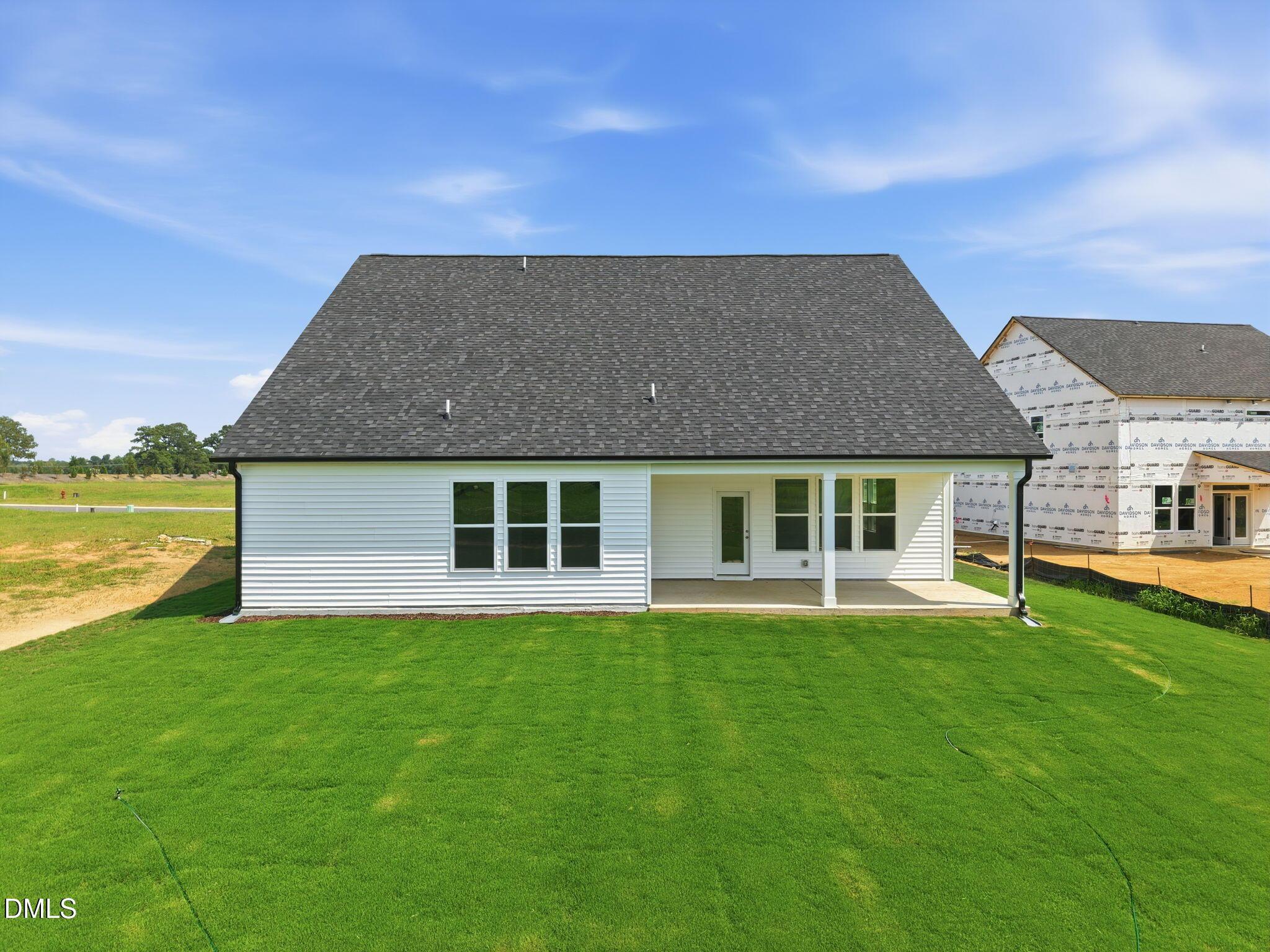 Back exterior of The Magnolia B floor plan by Davidson Homes featuring a covered patio at Retreat at North Main, Lillington.