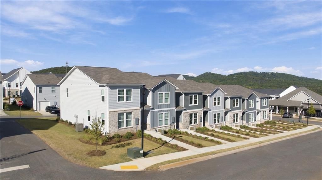 Row of modern two-story homes with gray and white siding in Stegall Village, Davidson Homes community, Emerson Georgia