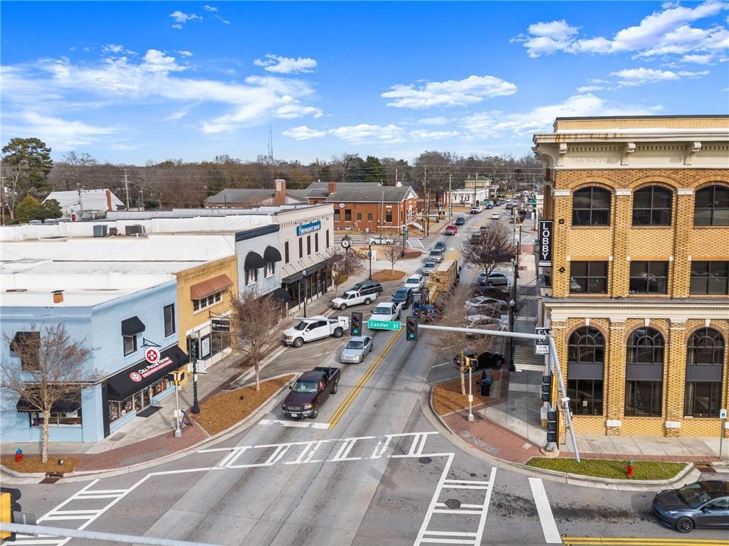 Aerial view of historic downtown Winder, Georgia, with brick buildings, shops, parked cars, and tree-lined streets near Cedar Farms