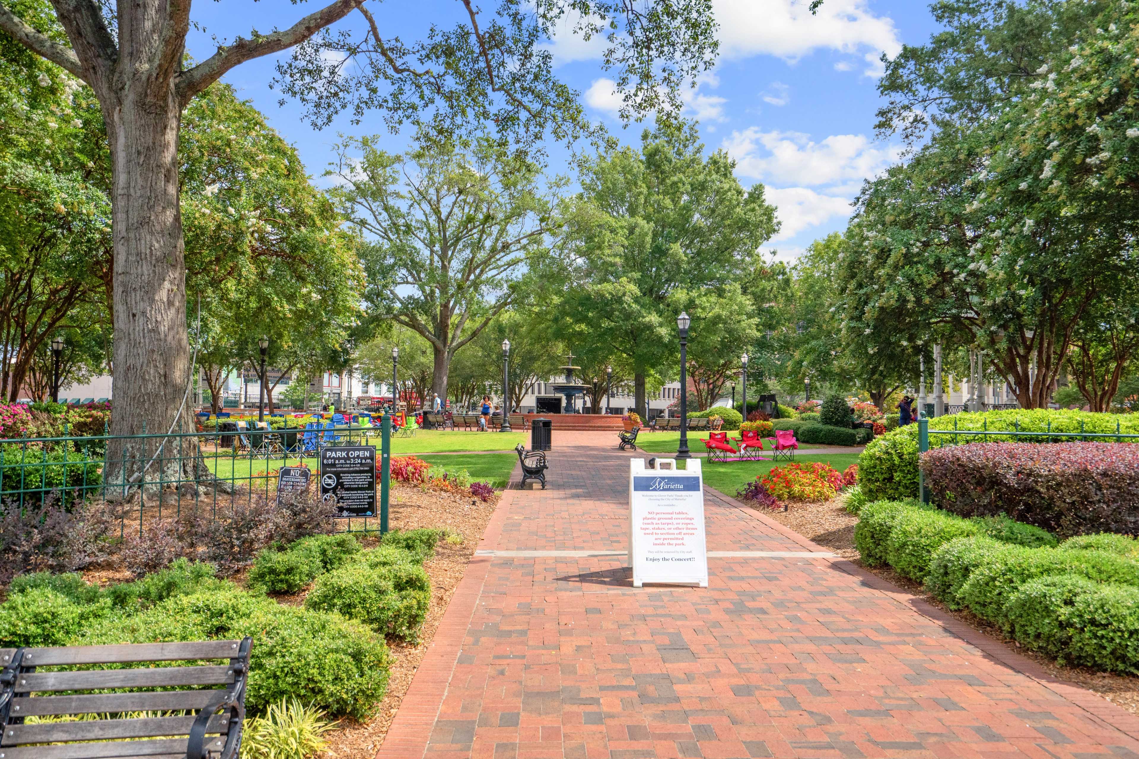 Scenic park at Rosehill Townhomes in Marietta GA with oak trees, brick pathways, benches, flowers, and gazebo