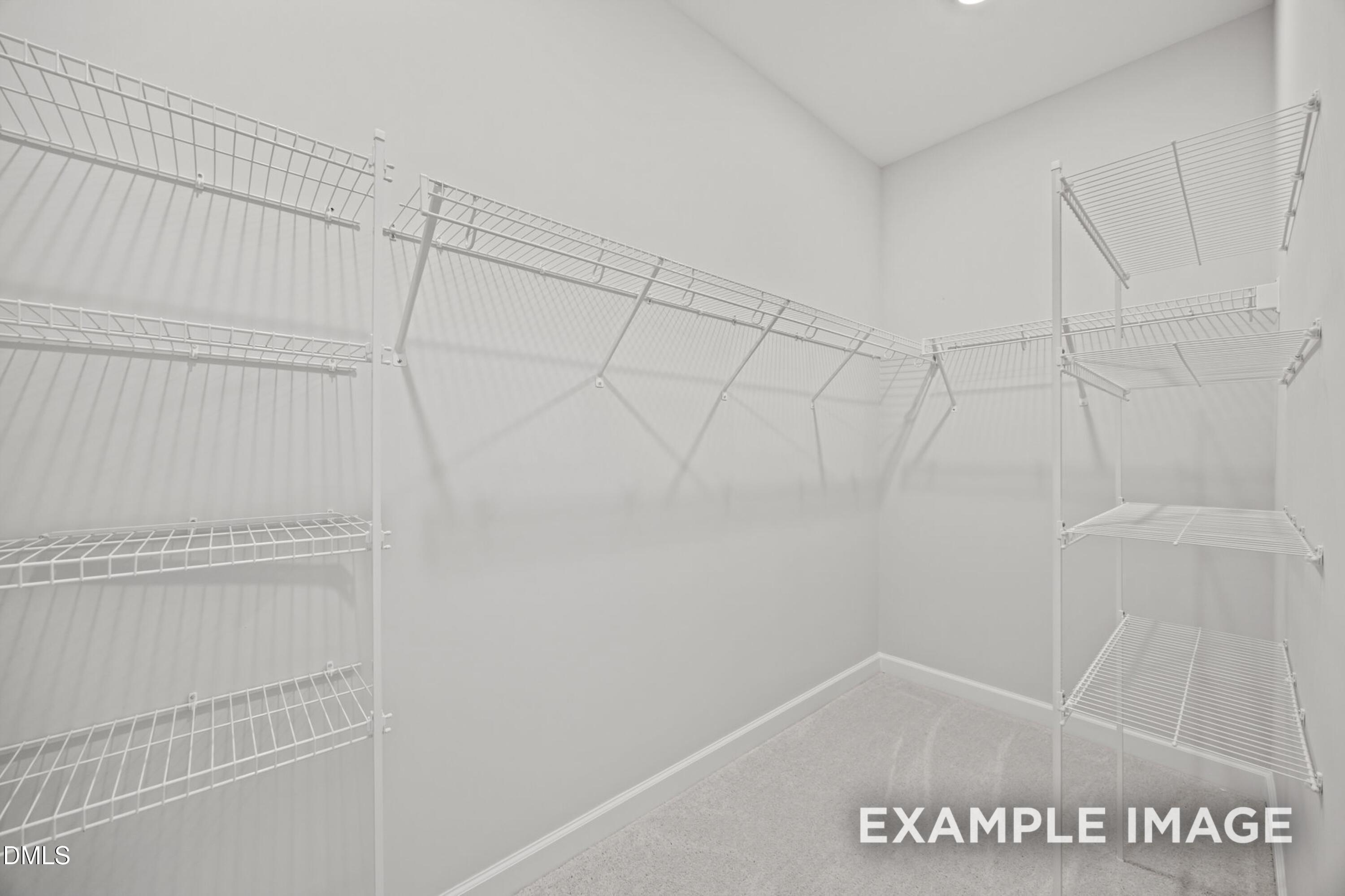 Walk-in closet with white wire shelving in The Alexander floor plan at Forestville Yard, Knightdale, North Carolina.