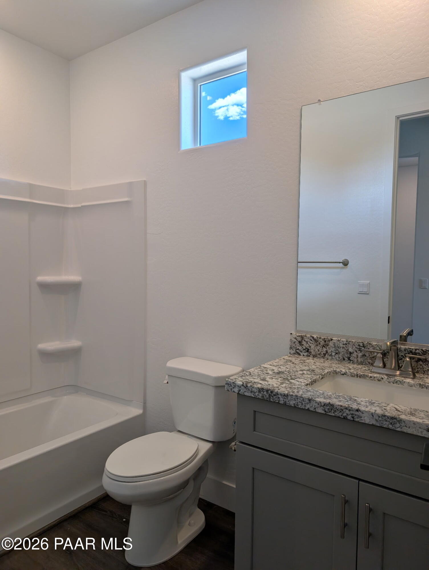 Modern bathroom with granite vanity and shower-tub combo in The Frontier II F floor plan at South Ranch, Prescott, Arizona.