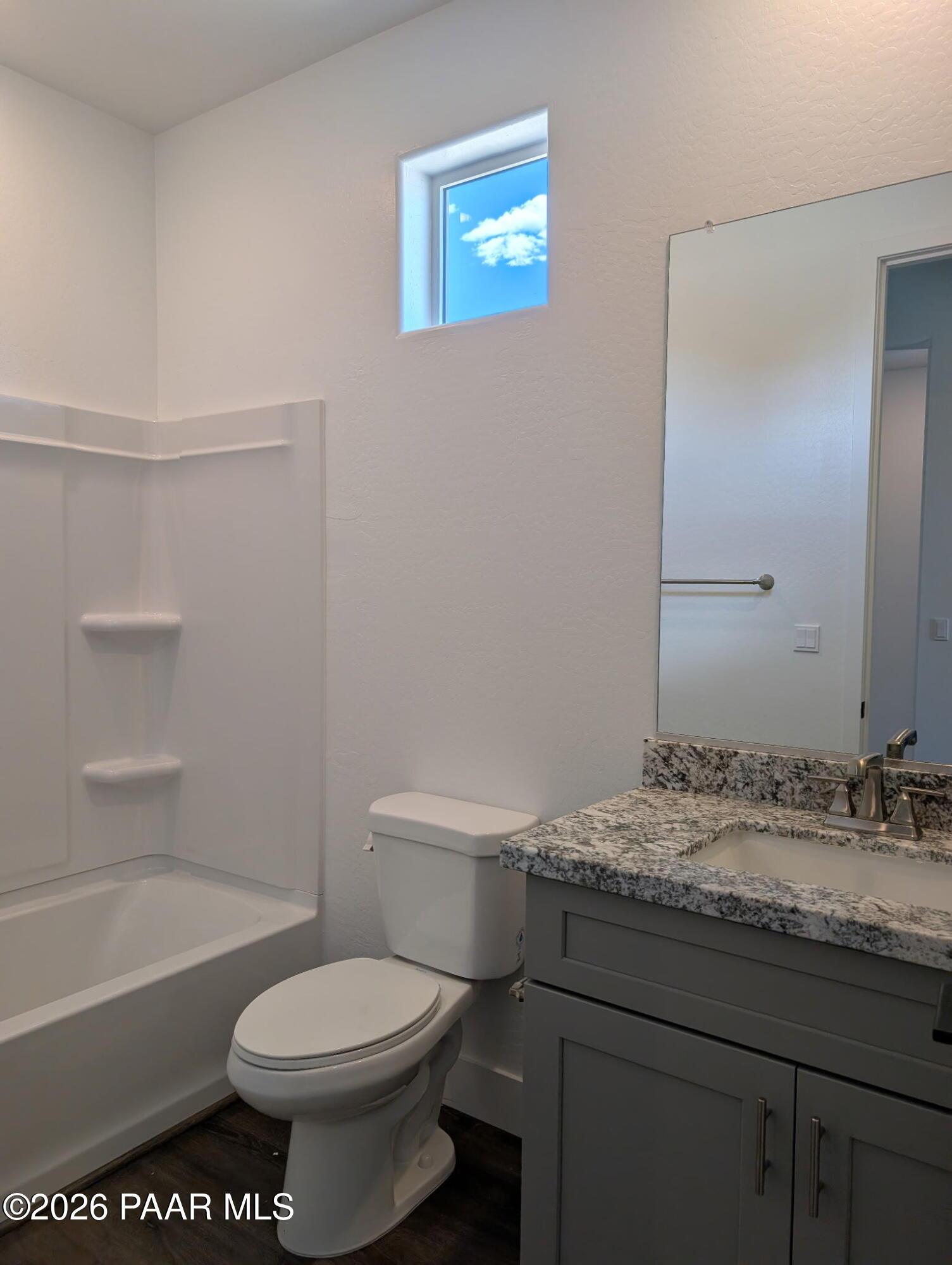 Modern bathroom with granite vanity and shower-tub combo in The Frontier II F floor plan at South Ranch, Prescott, Arizona.