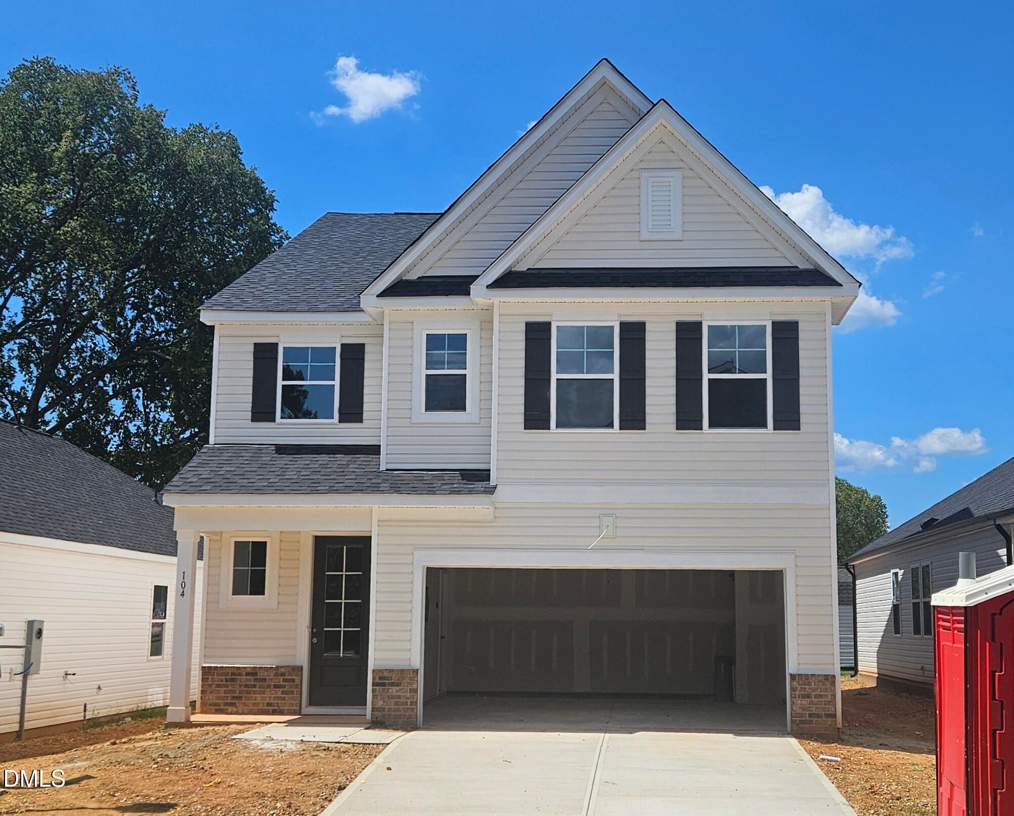 Two-story white siding new home with black shutters and 2-car garage in Gregory Village by Davidson Homes, Lillington NC