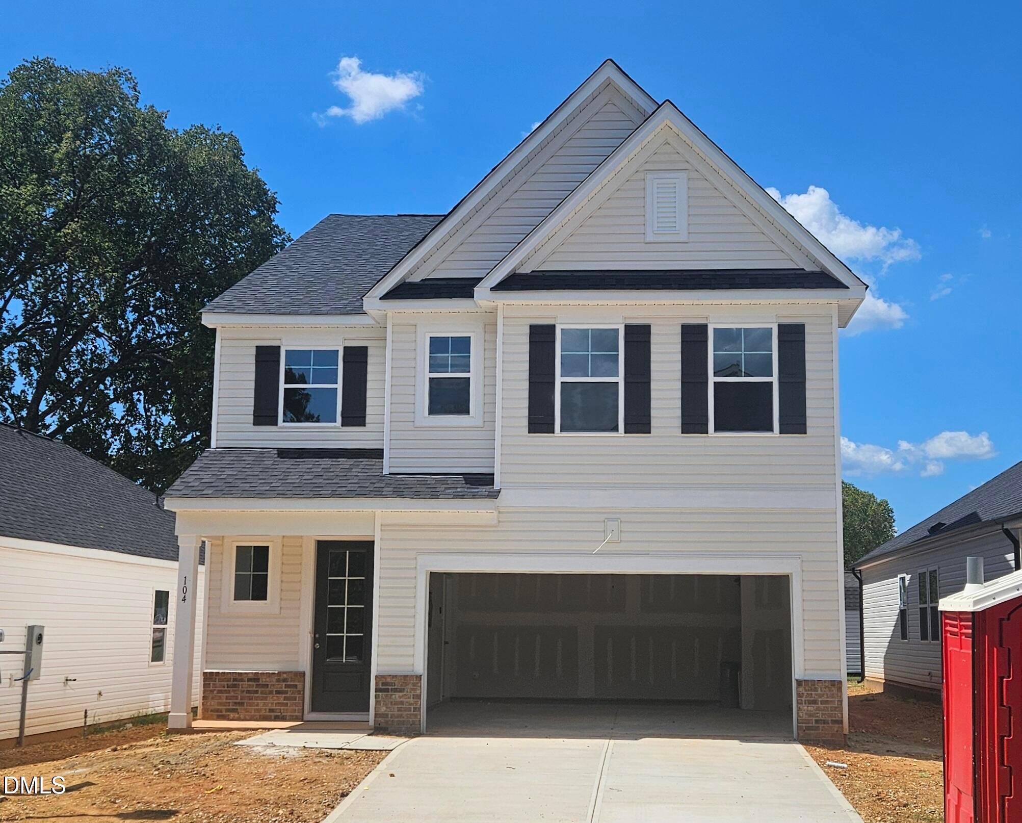 Two-story white siding new home with black shutters and 2-car garage in Gregory Village by Davidson Homes, Lillington NC