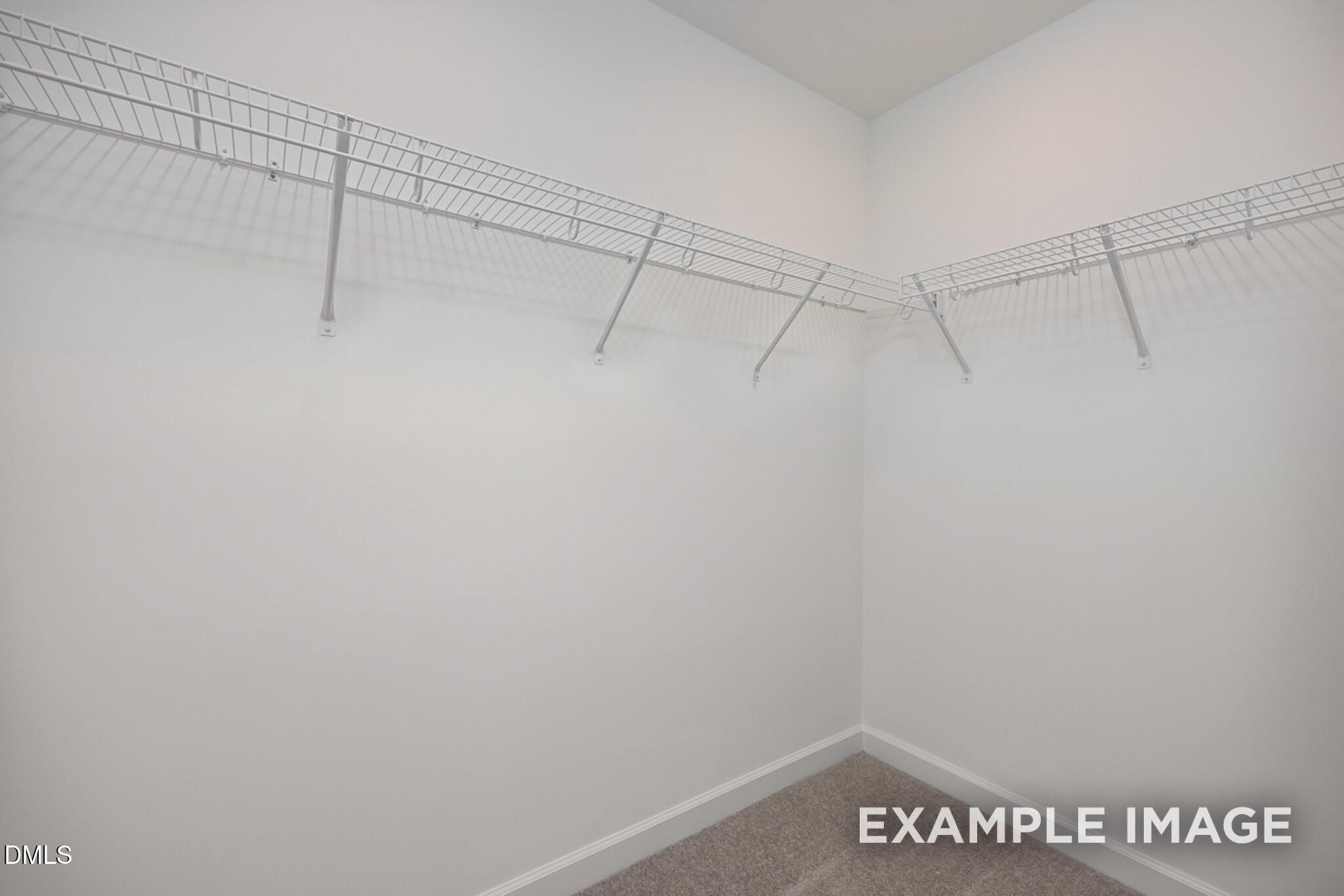 Walk-in closet with white wire shelving in The Mitchell Interior floor plan at Camden Park, Knightdale, North Carolina.