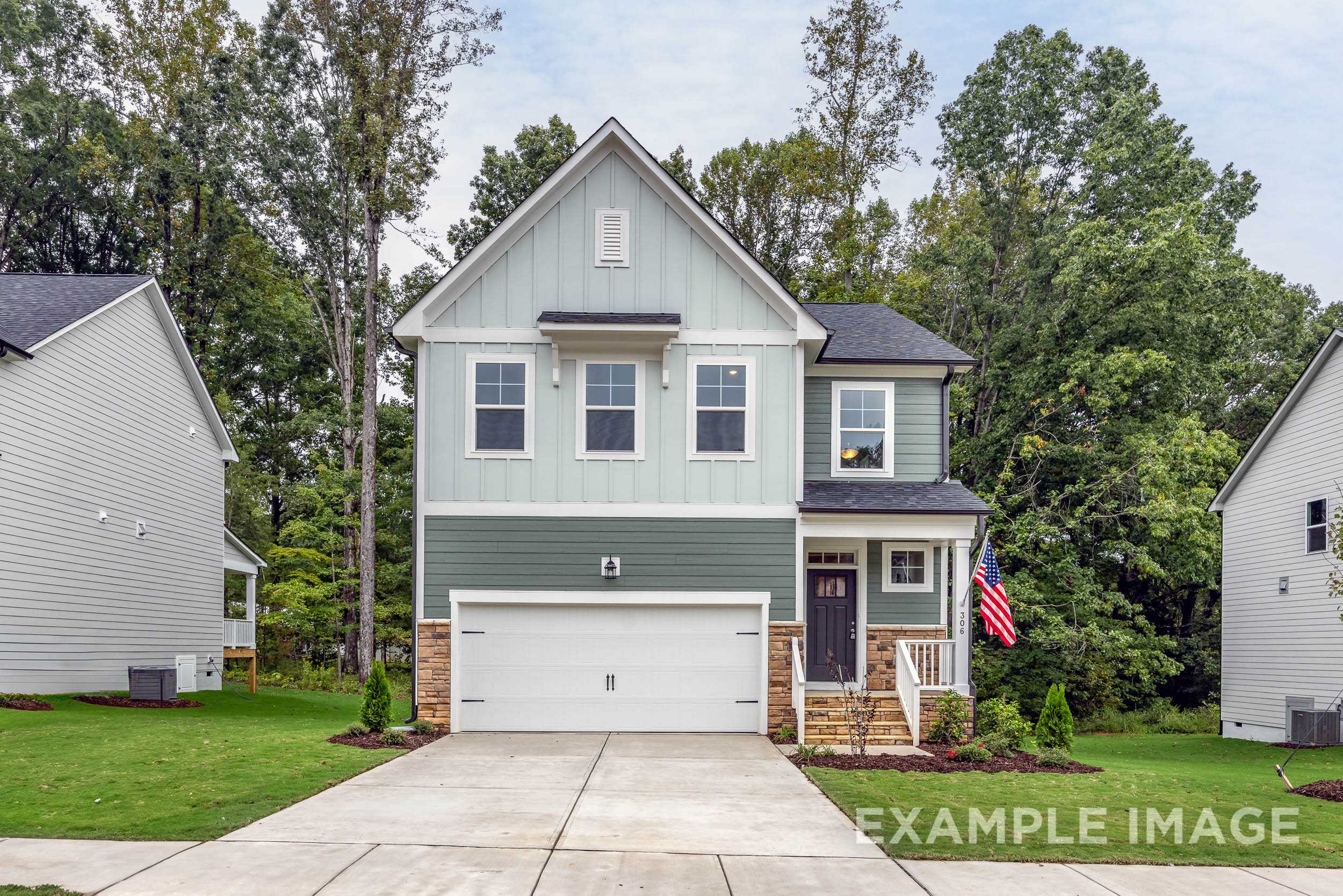 Modern two-story The Gavin B home elevation with light blue siding, dark roof, two-car garage, and front porch in Lillington NC