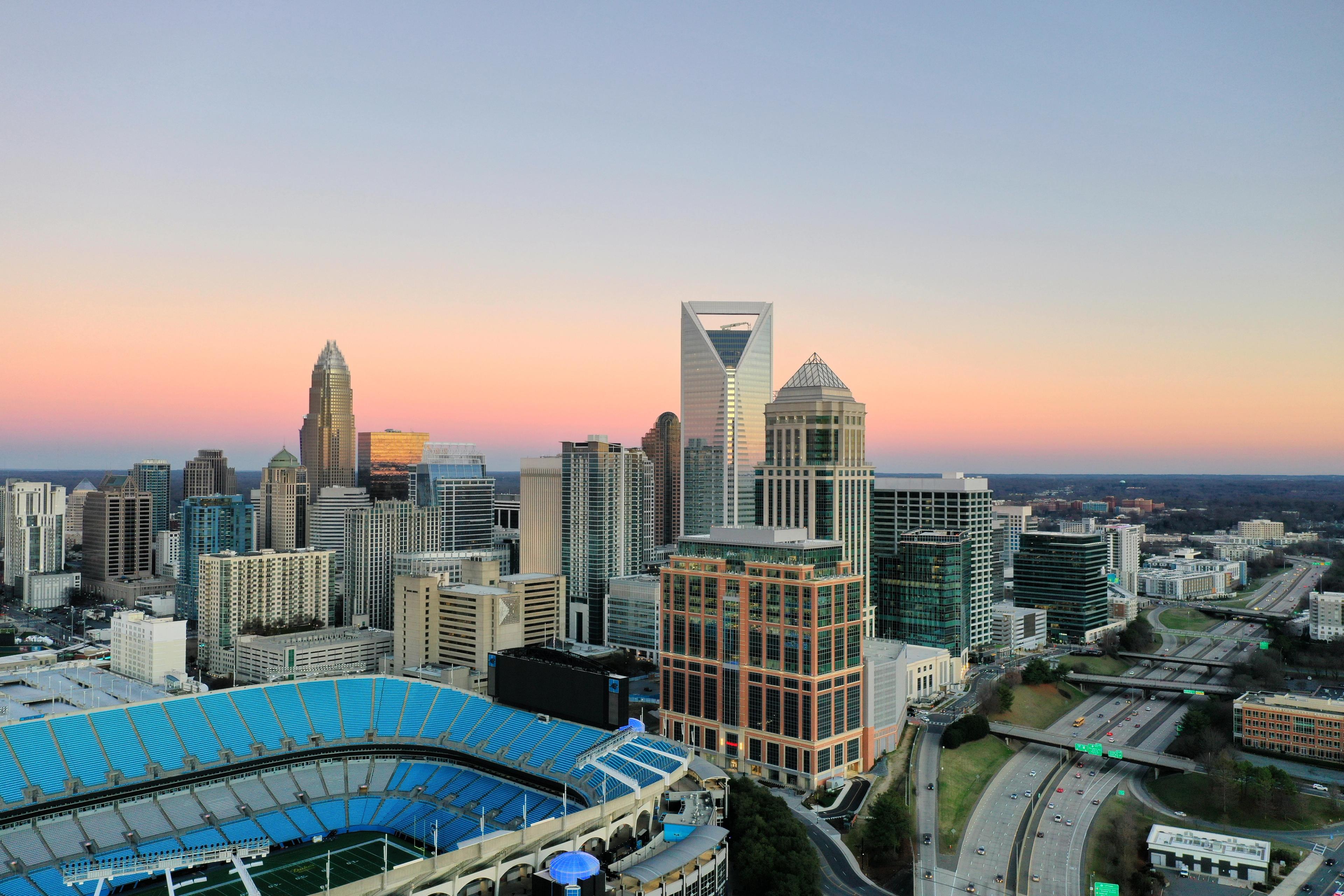 Aerial view of Charlotte, North Carolina skyline at sunset near Long Creek Townhomes by Davidson Homes.