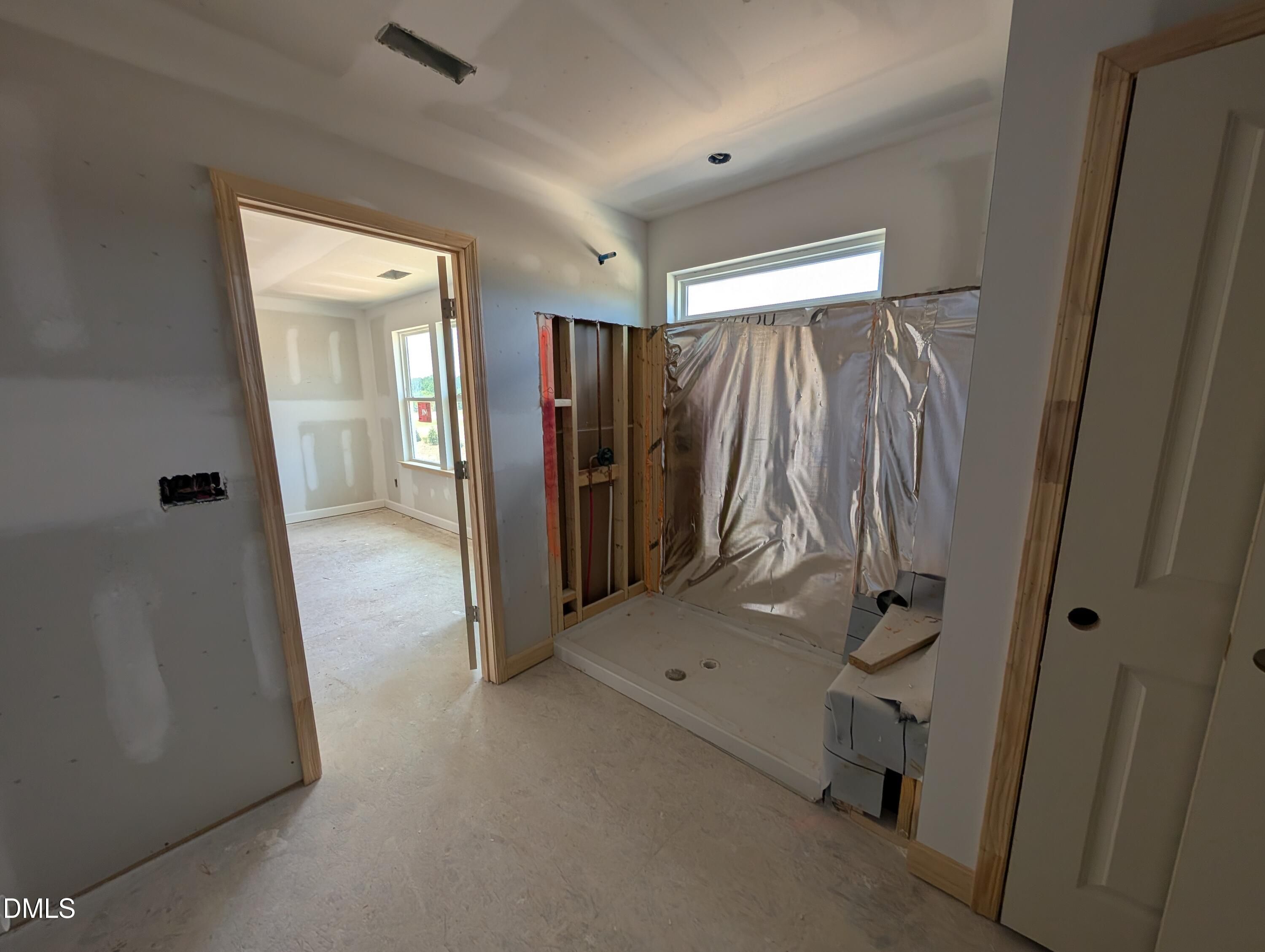 Unfinished master bathroom shower installation in The Chestnut floor plan by Davidson Homes at Wendell Ridge, North Carolina.