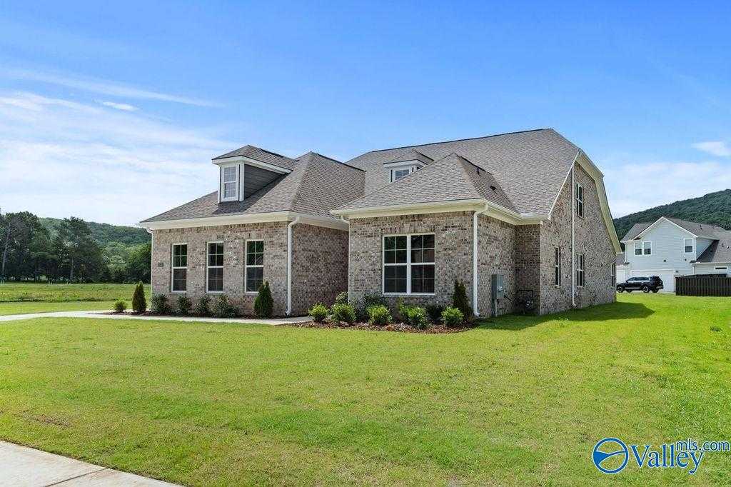 The Oxford 5-bed brick home by Evermore Homes: 1.5-story exterior with gabled roof, 3-car garage, lush lawn in The Meadows at Hampton Cove, Owens Cross Roads, AL