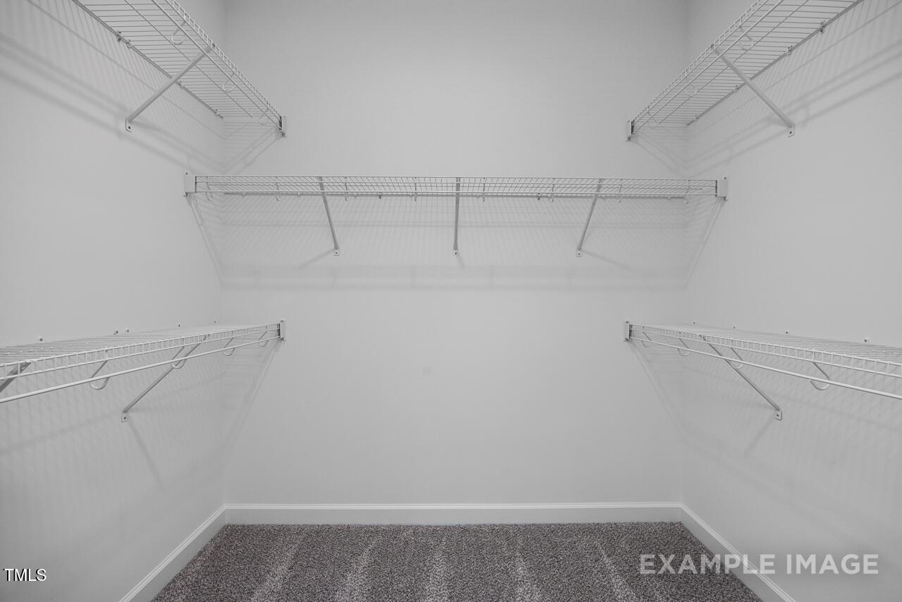 Spacious walk-in closet with white wire shelving in master suite, The Magnolia B by Davidson Homes, Angier, NC