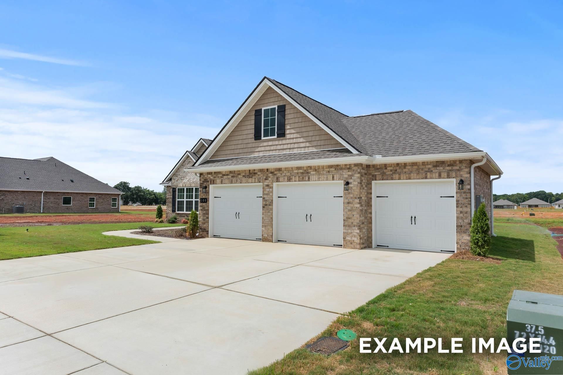 Two-story brick home with 3-car garage, driveway, and landscaped yard in Kendall Farms, Toney, Alabama - Davidson Homes The Emory