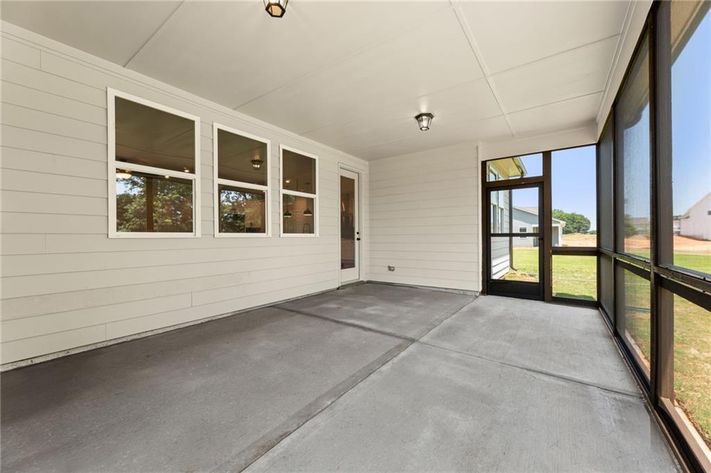 Screened back porch with large screened windows, concrete floor, and French doors in Davidson Homes The Harrison G, Winder, GA