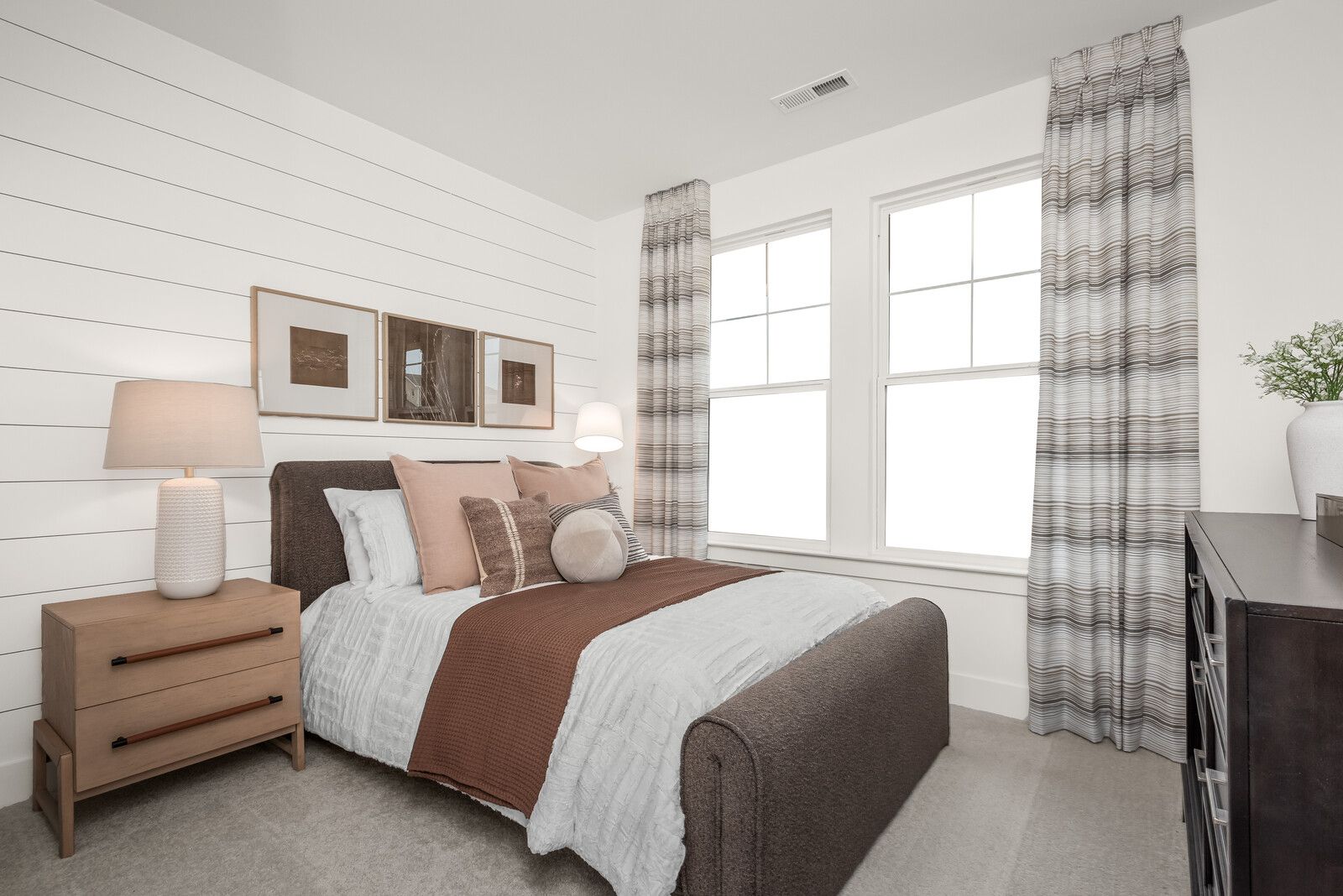 Cozy bedroom with shiplap walls, gray upholstered bed, neutral pillows and large windows at Benders Cove Mt. Juliet TN
