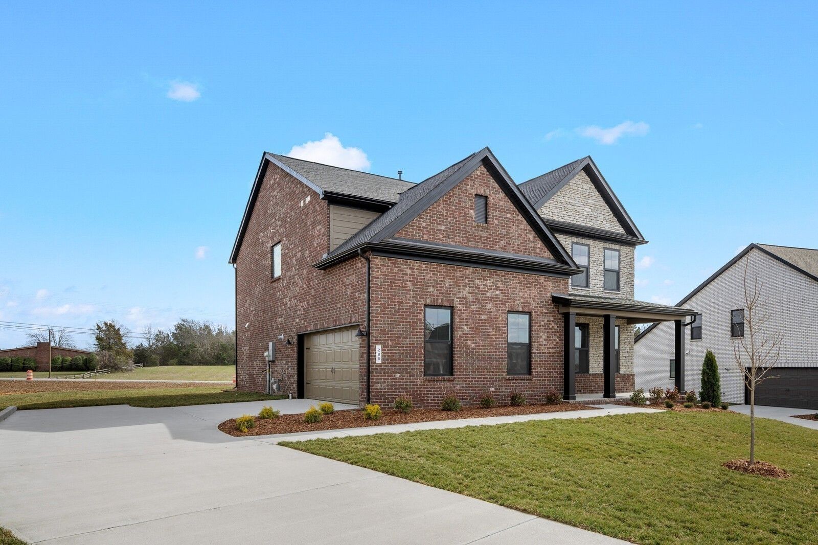 Two-story brick and stone home with a 2-car garage, The Henry C floor plan by Davidson Homes in Benders Cove, Mt. Juliet.