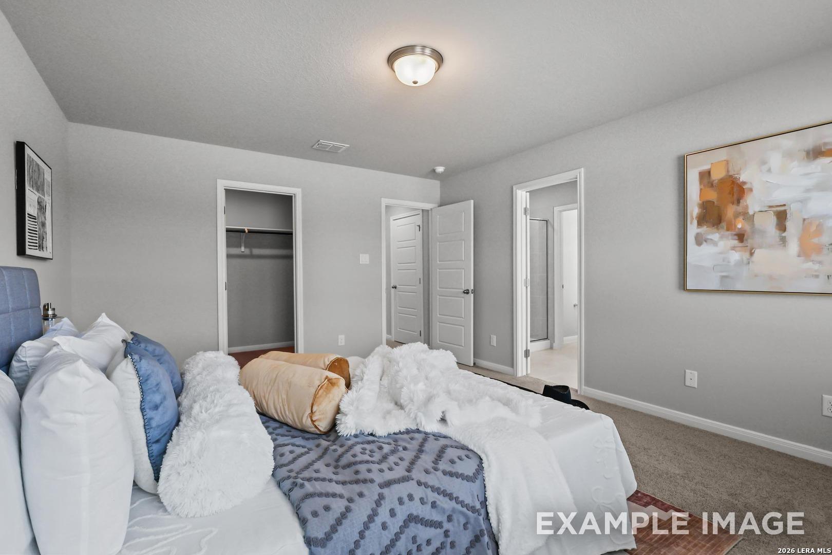 Spacious master bedroom with walk-in closet and en-suite bath in The Gillian A floor plan by Davidson Homes in San Antonio.