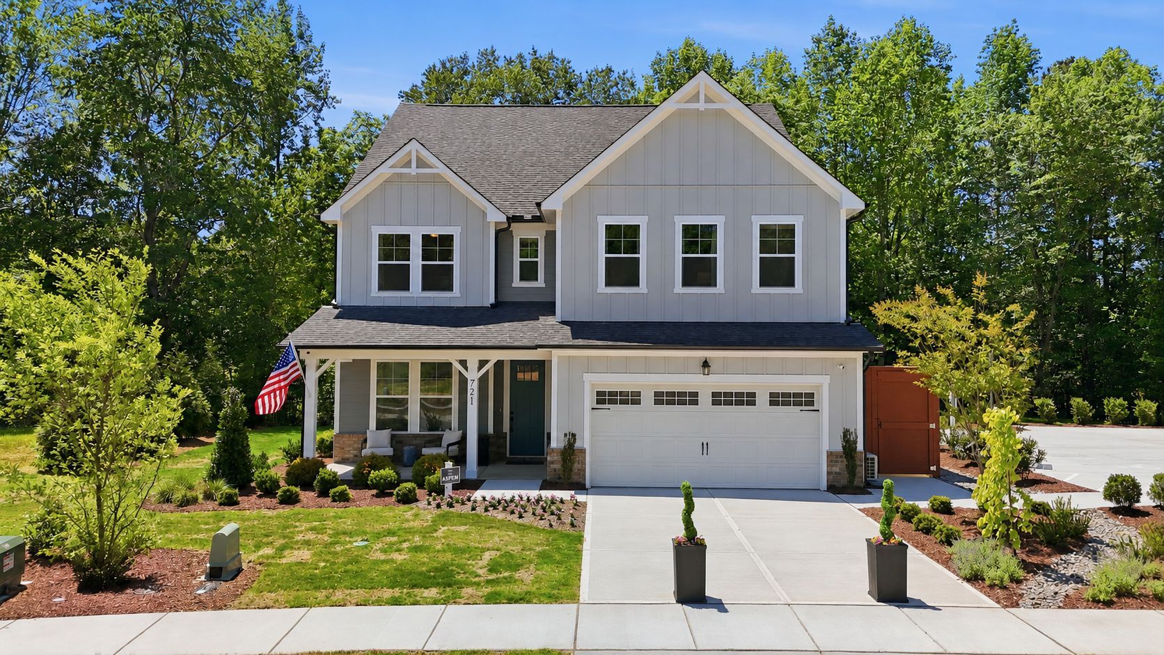 Davidson Homes exterior at Wendell Ridge in Wendell, North Carolina, featuring a covered front porch and two-car garage.