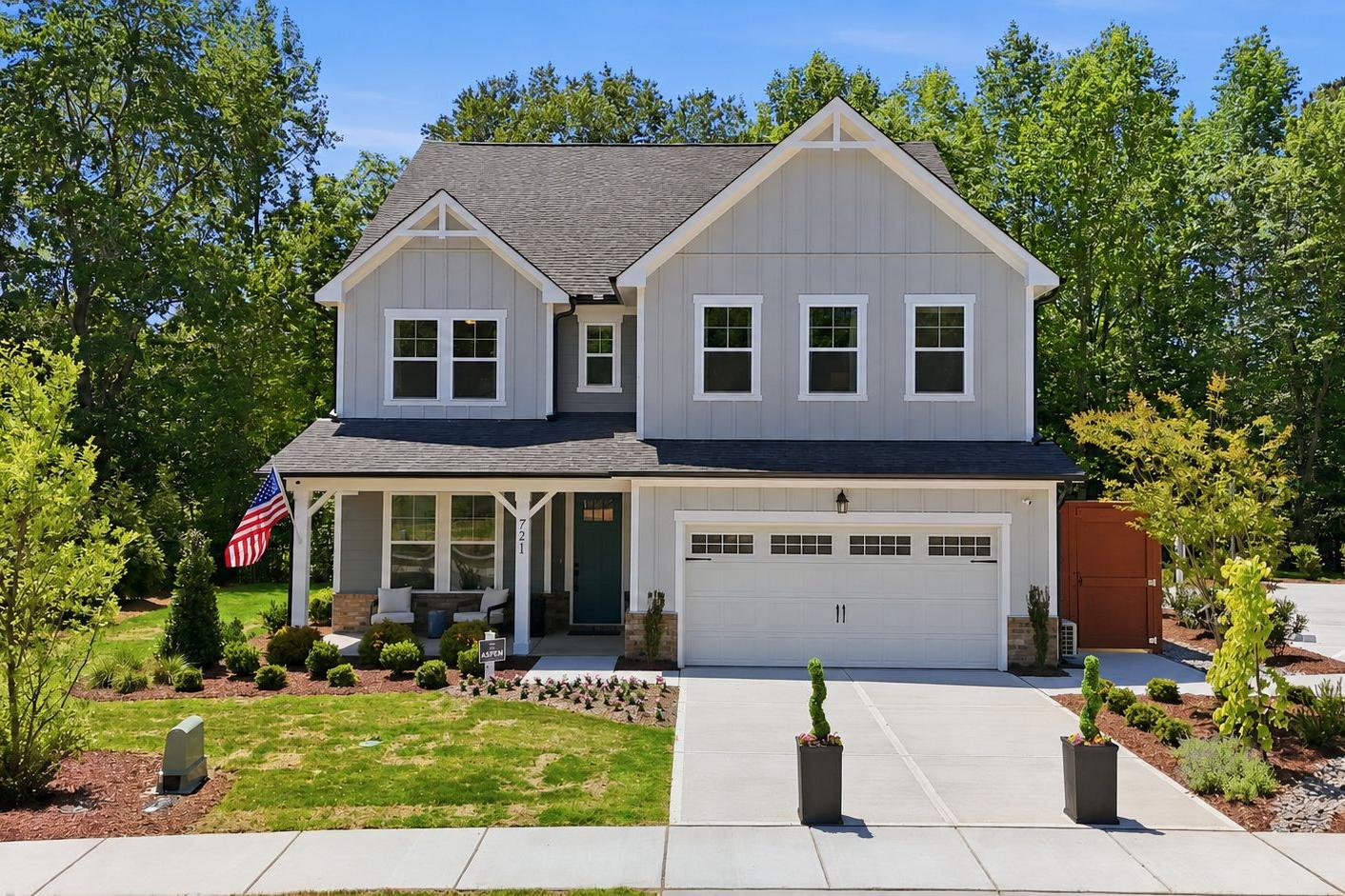Davidson Homes exterior at Wendell Ridge in Wendell, North Carolina, featuring a covered front porch and two-car garage.