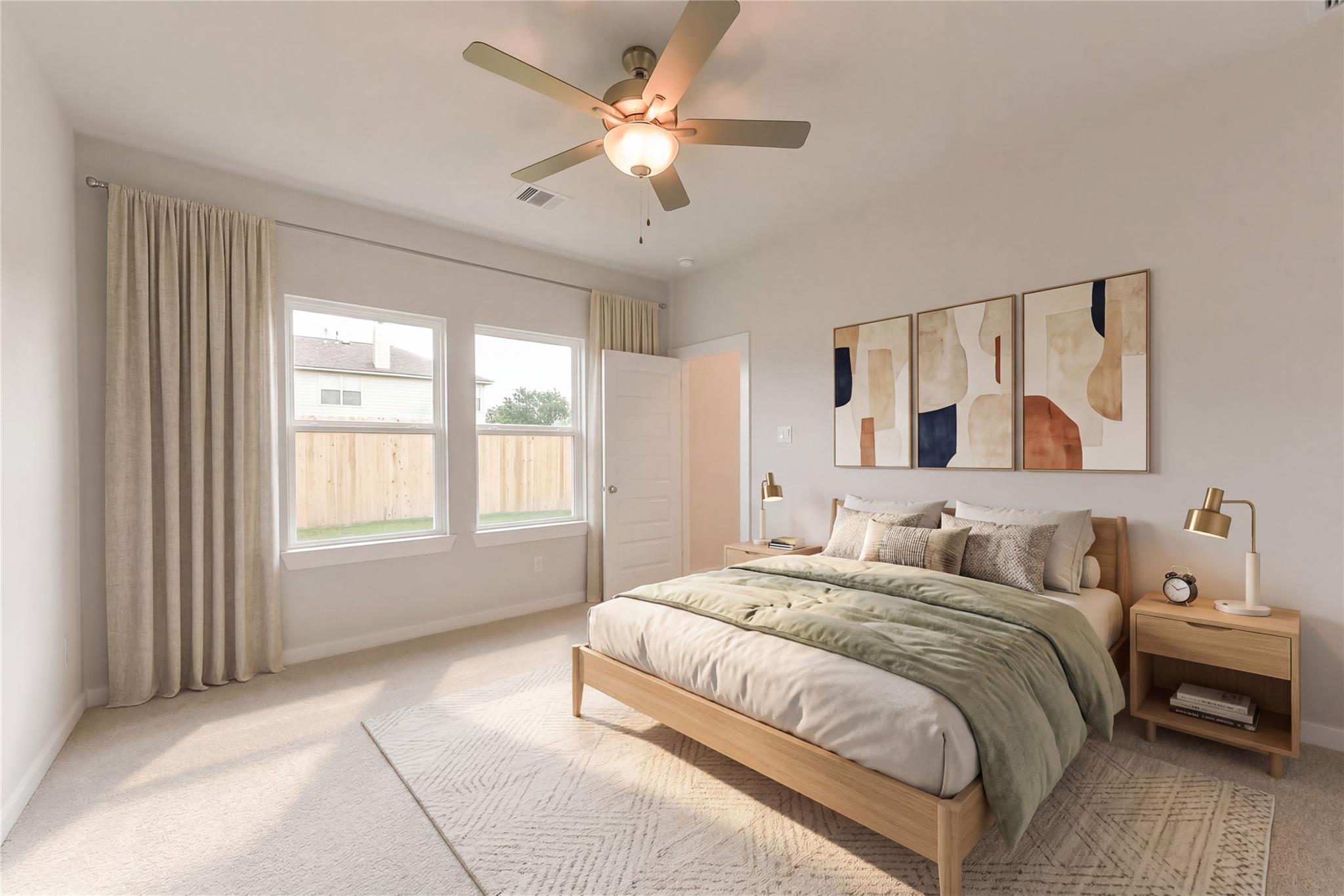Bright master bedroom with wooden king bed, green bedding, abstract art, and window views in Davidson Homes The Brazos E, Dayton Texas