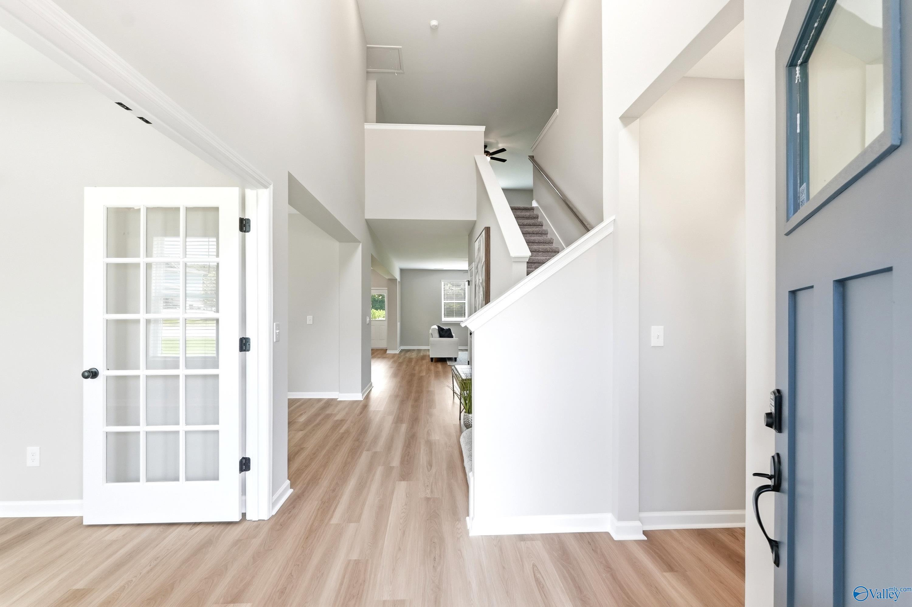 Bright, open foyer with vaulted ceilings and wood-style flooring in The Dorado floor plan at Riverton Preserve, Huntsville.