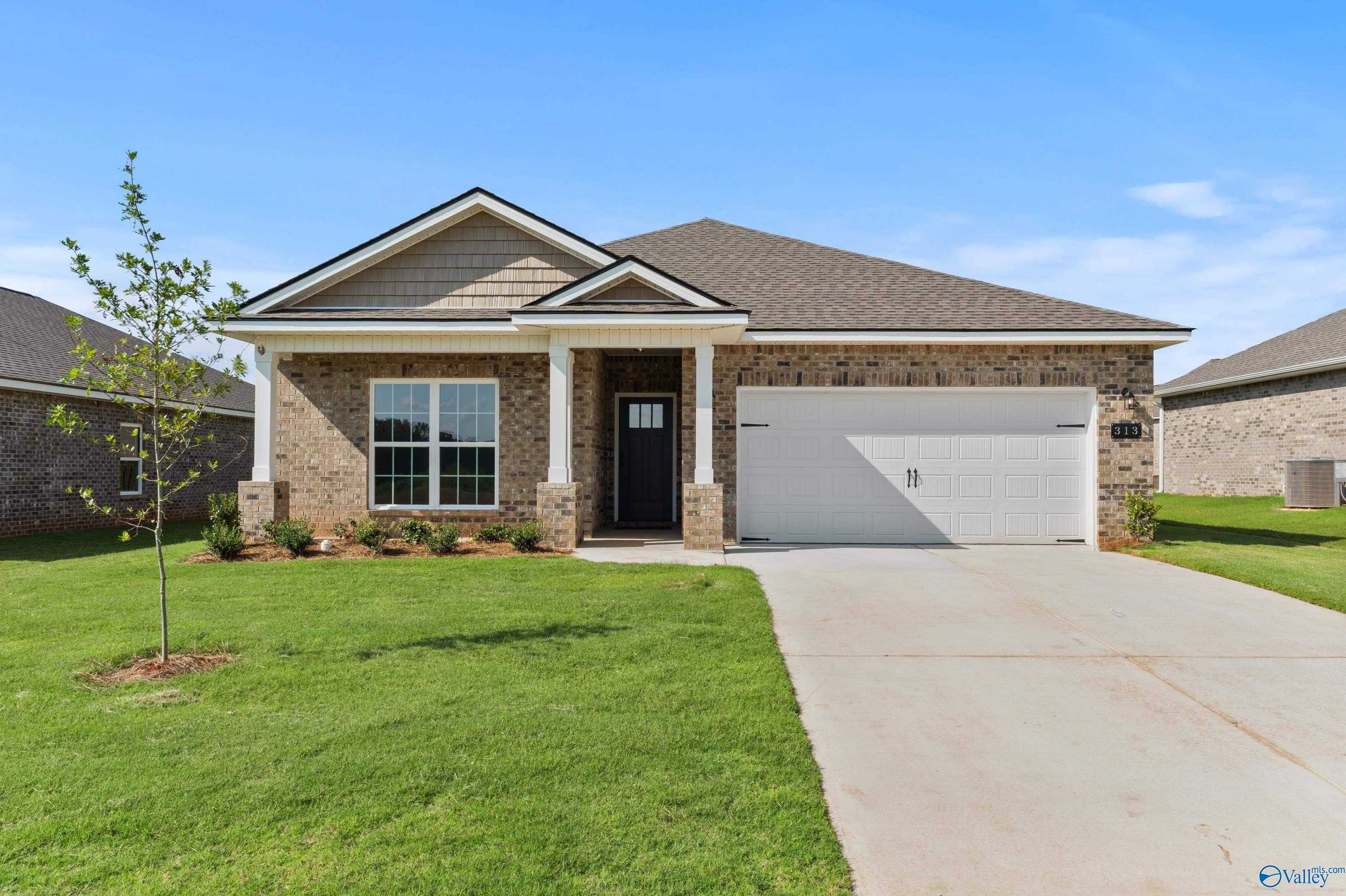 Charming single-story brick home with 2-car garage, covered porch, and manicured lawn in Clearview, Hazel Green, Alabama