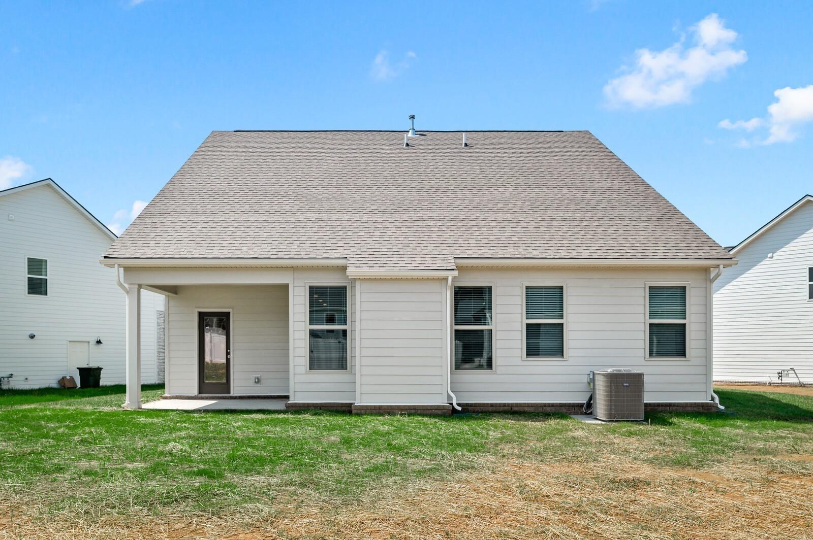 Back exterior view of The Ash A floor plan by Davidson Homes featuring a covered patio in Woods Crossing, Gallatin, TN.