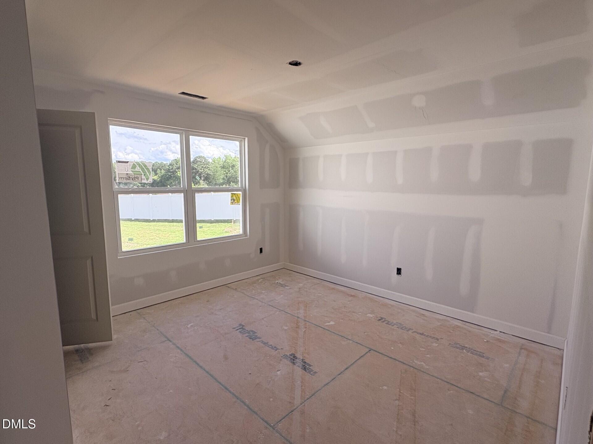 Unfinished bedroom with drywall in The Ash C floor plan by Davidson Homes at Woodland Crossing, Zebulon, North Carolina.