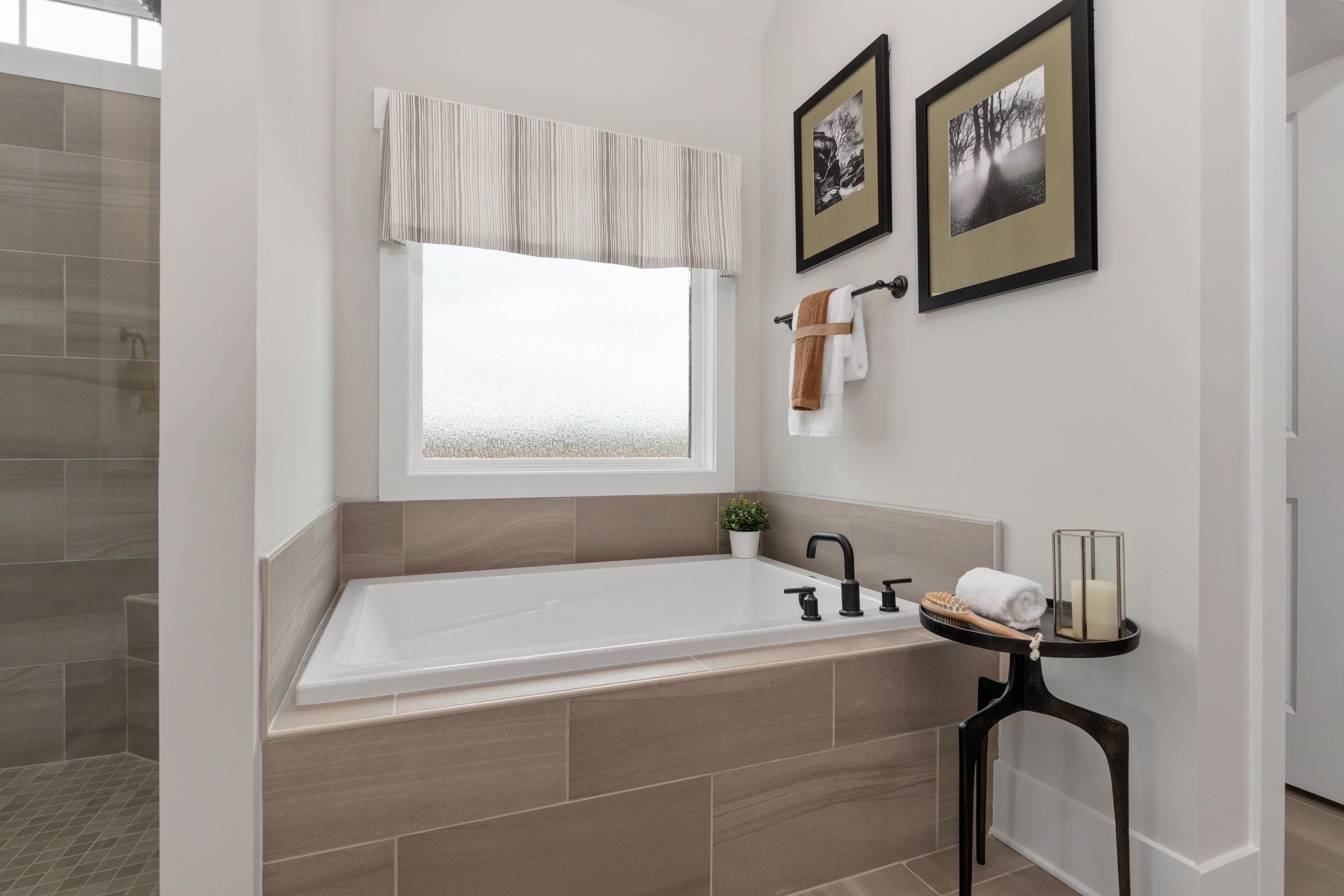 Spacious master bathroom at Briercreek in Meridianville Alabama with soaking tub, walk-in shower, and neutral tile
