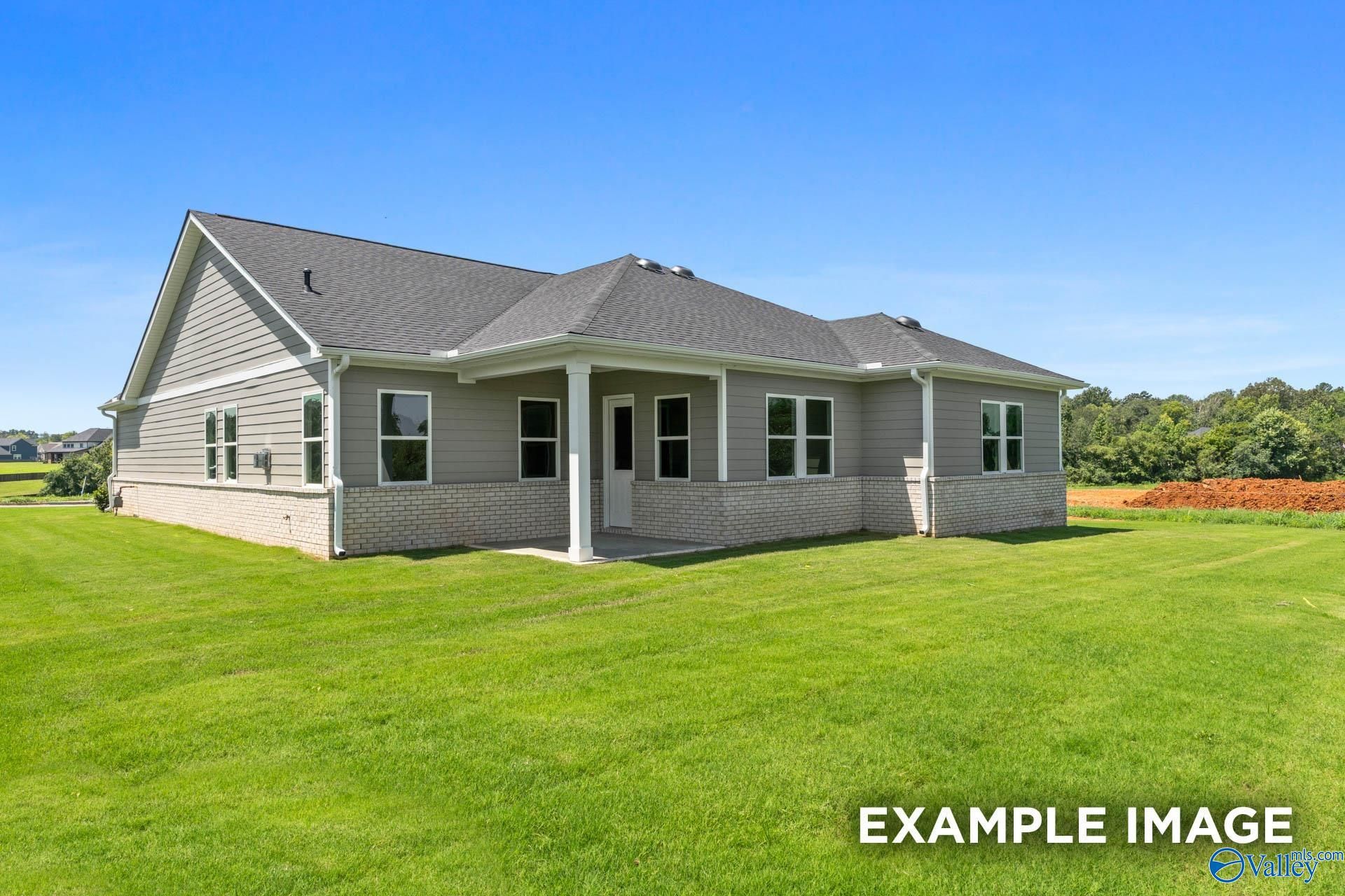 Single-story 4-bedroom Arcadia home by Evermore Homes with covered porch, brick accents, and lush green lawn in Owens Cross Roads, Alabama