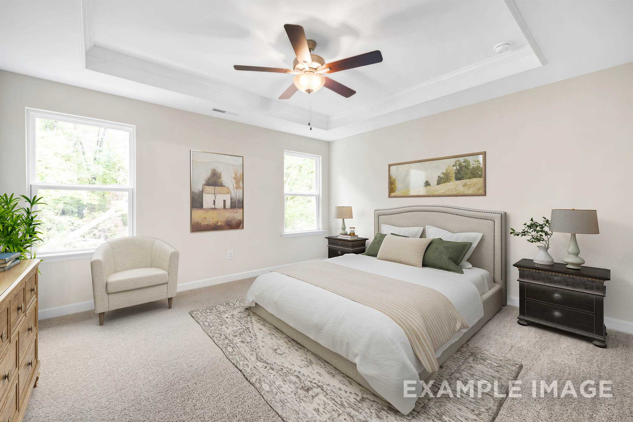 Spacious master bedroom in The Gavin C with king bed, ceiling fan, beige walls, windows, and neutral decor