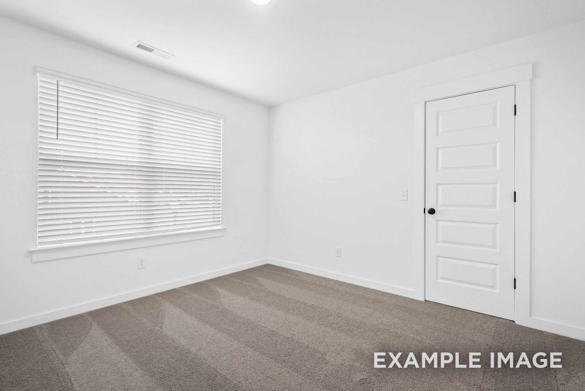 Bright empty bedroom with white walls, large window blinds, gray carpet in 5-bedroom Ridgeport C home, Gallatin, Tennessee