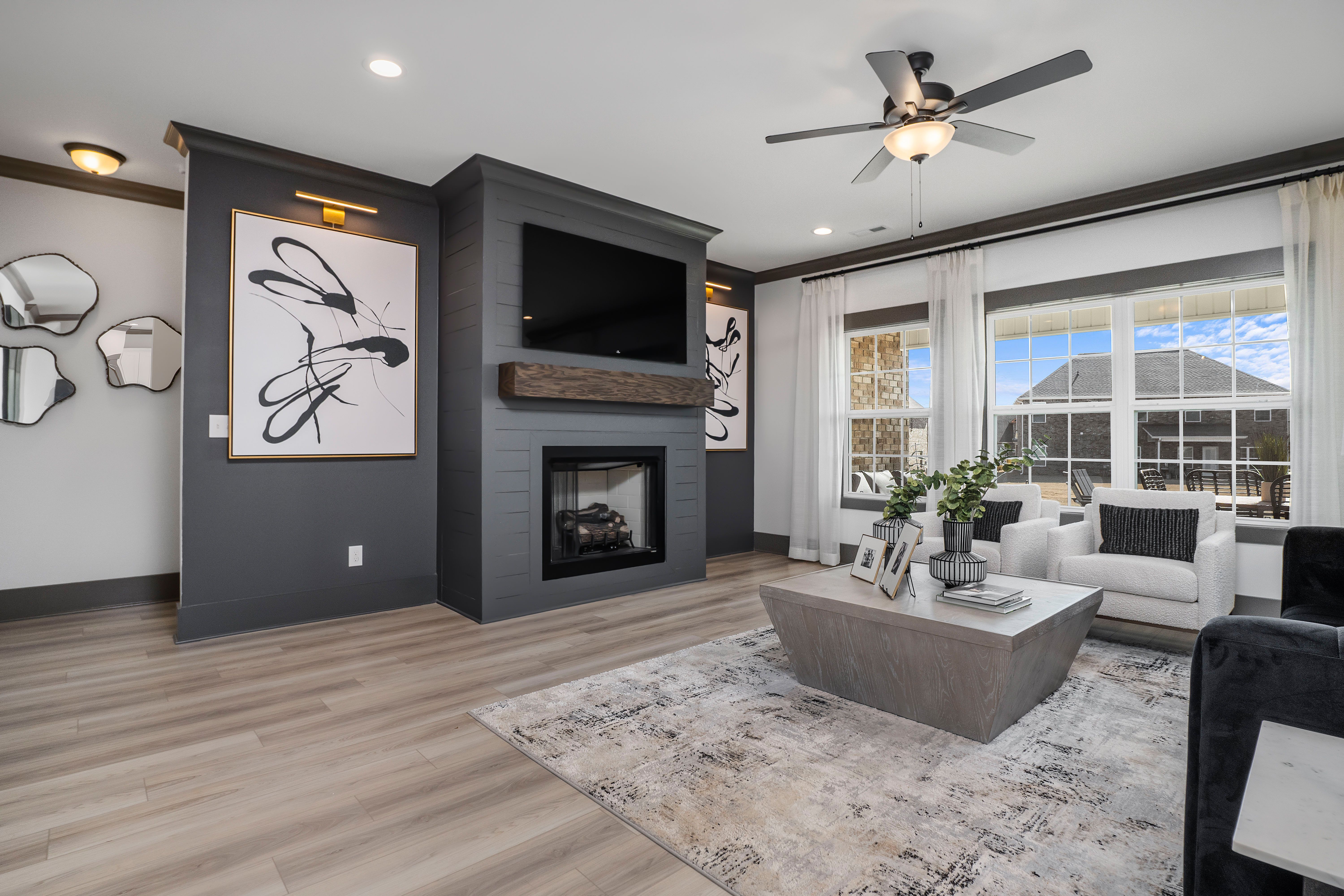Modern living room in Barnett's Crossing Madison Alabama with gas fireplace, hardwood floors, and abstract wall art