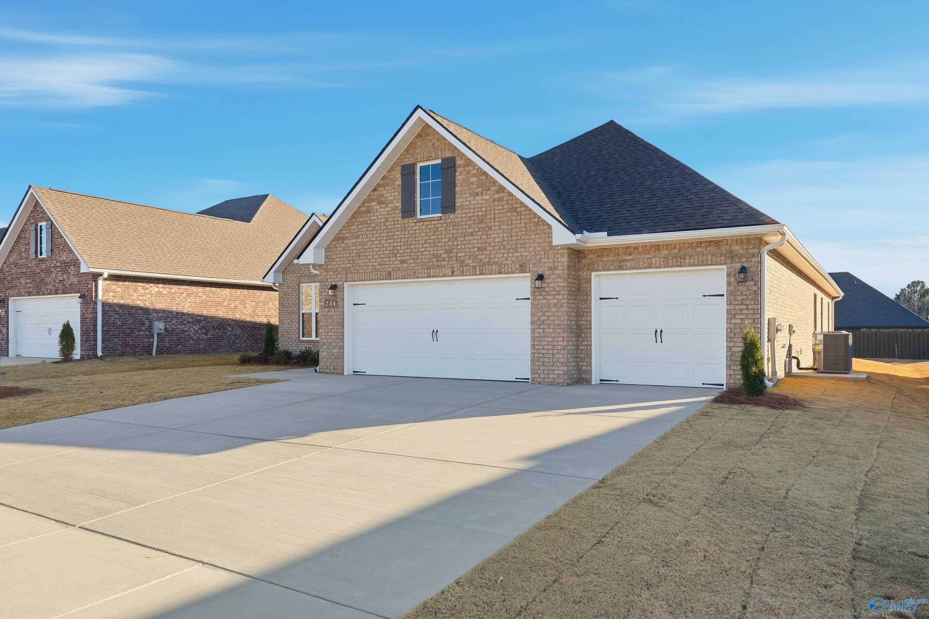 Brick 1-story home with gabled roof, 2-car garage, and driveway in Kendall Downs, Toney, Alabama - Davidson Homes The Lanier