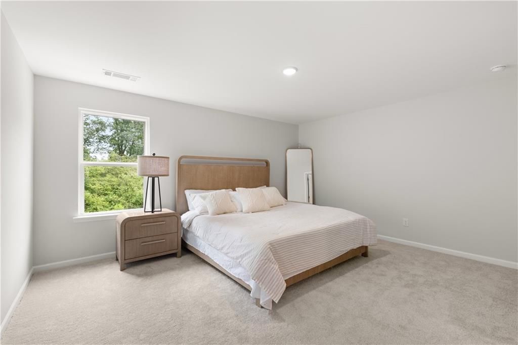 Spacious bedroom with neutral decor in The Sinclair B floor plan at Cedar Farms, Winder, Georgia.