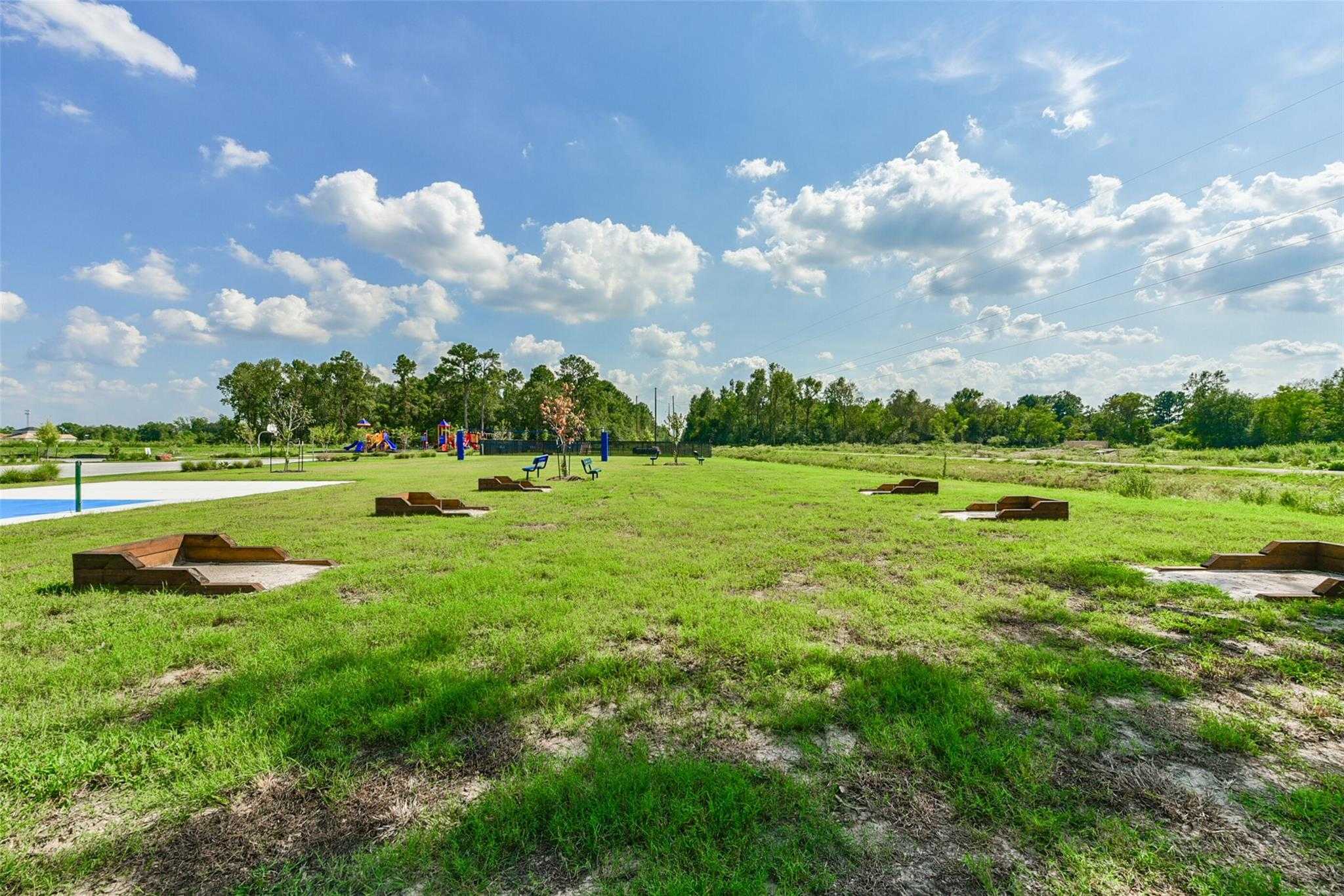 Scenic community park with playground, pool, and benches in The Villages at WestPointe, Dayton, Texas