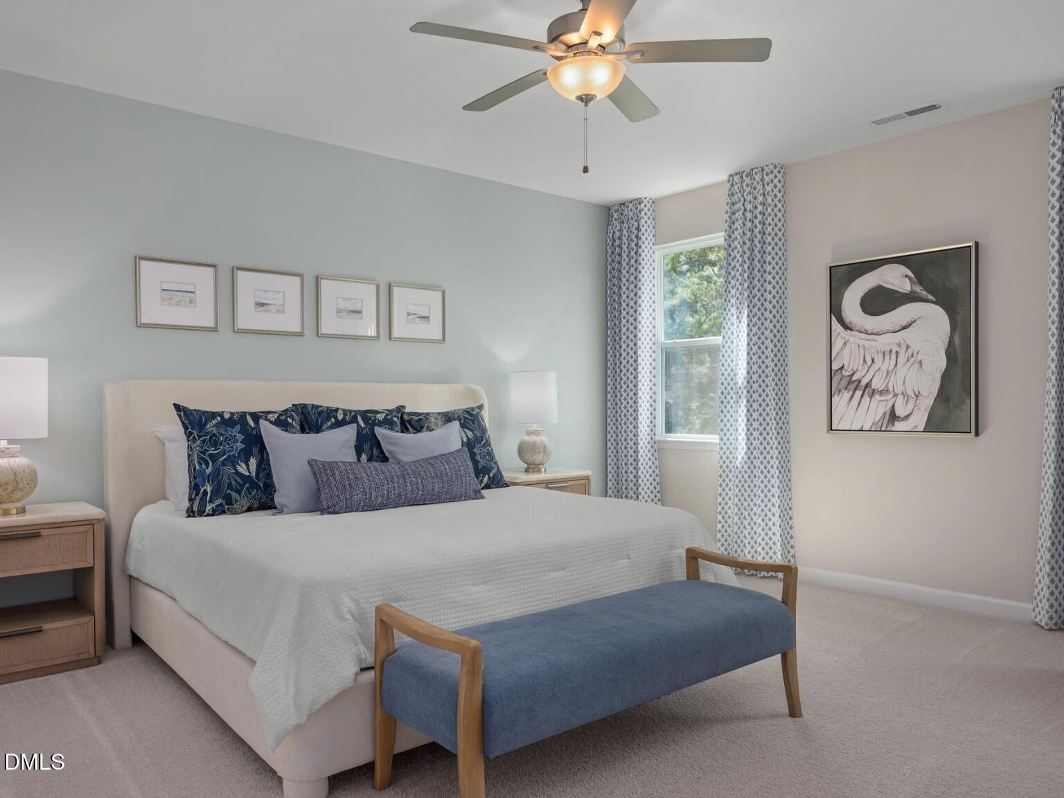 Serene bedroom with light blue walls, beige king bed, blue pillows, ceiling fan, and swan artwork in Davidson Homes The Hickory II D, Wake Forest, NC
