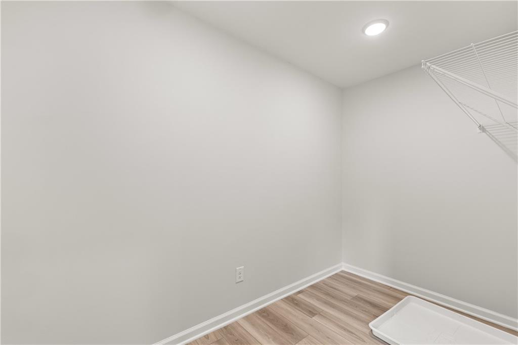 Laundry room with wire shelving and drip tray in The Russell A floor plan by Davidson Homes in Cedar Farms, Winder, GA