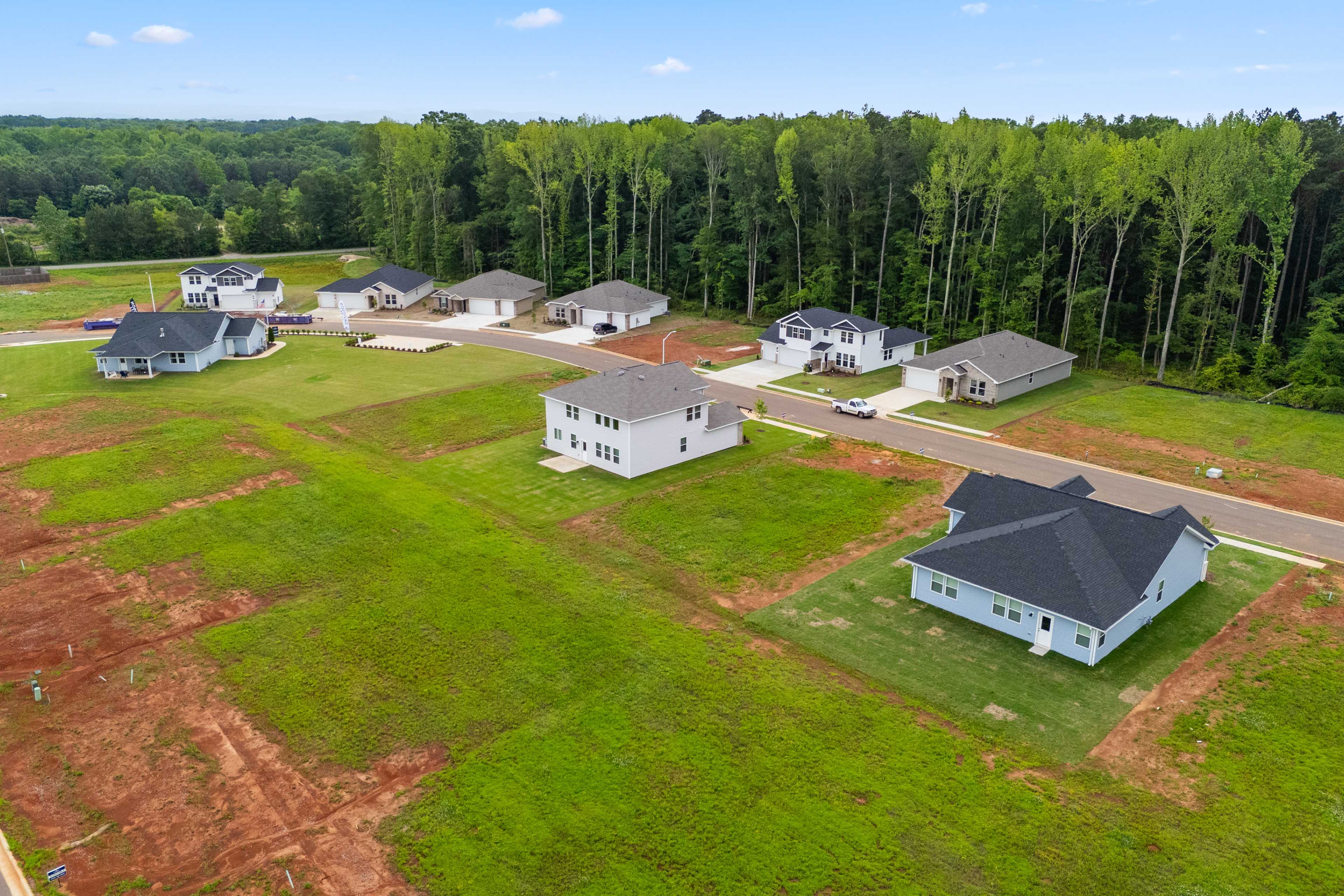 Aerial view of new homes in Forest Glen, Hazel Green Alabama, surrounded by lush trees and green lots