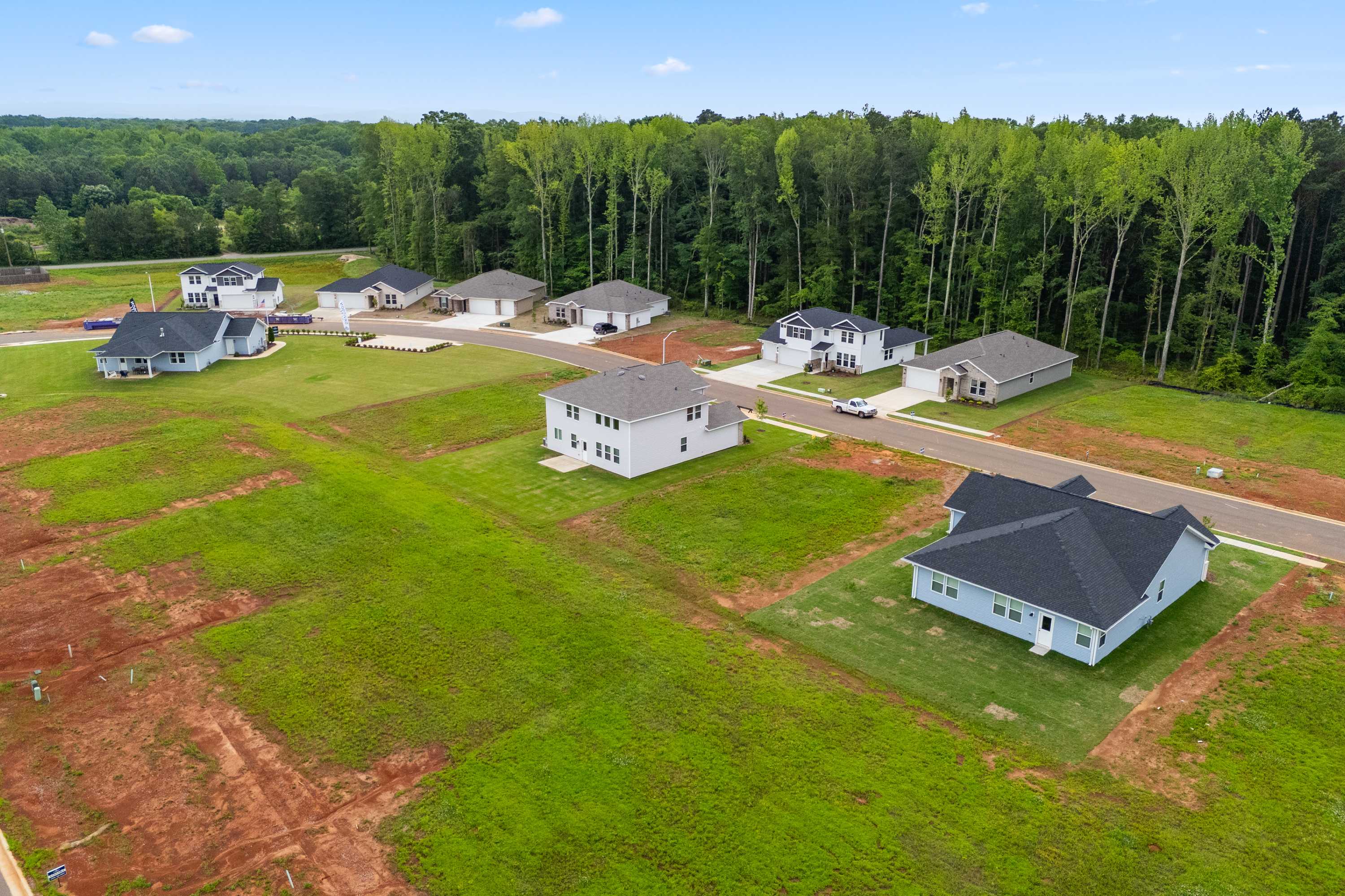Aerial view of new homes in Forest Glen, Hazel Green Alabama, surrounded by lush trees and green lots