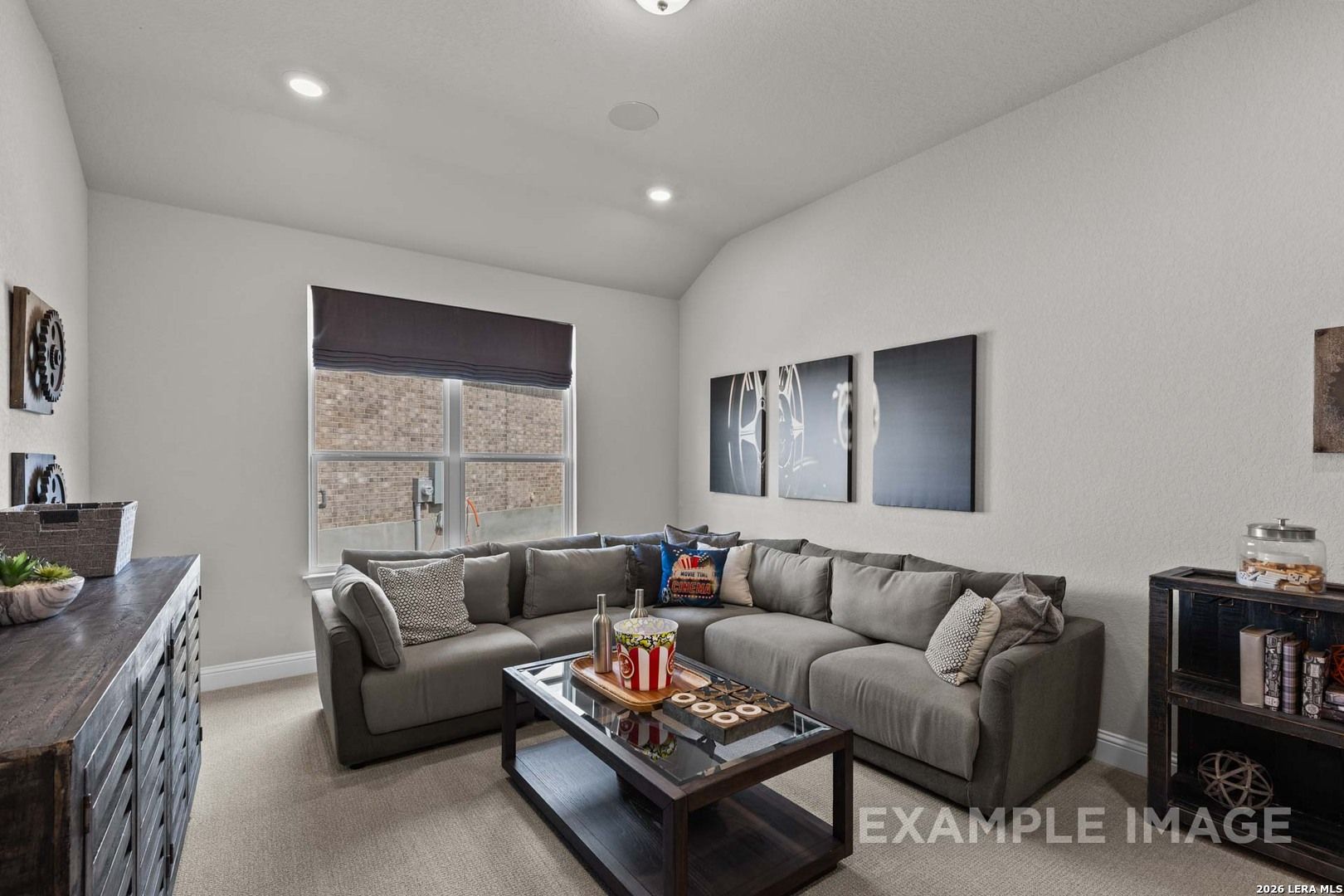 Cozy media room with large grey sectional in The Garner C floor plan by Davidson Homes in The Reserve at Potranco Oaks.