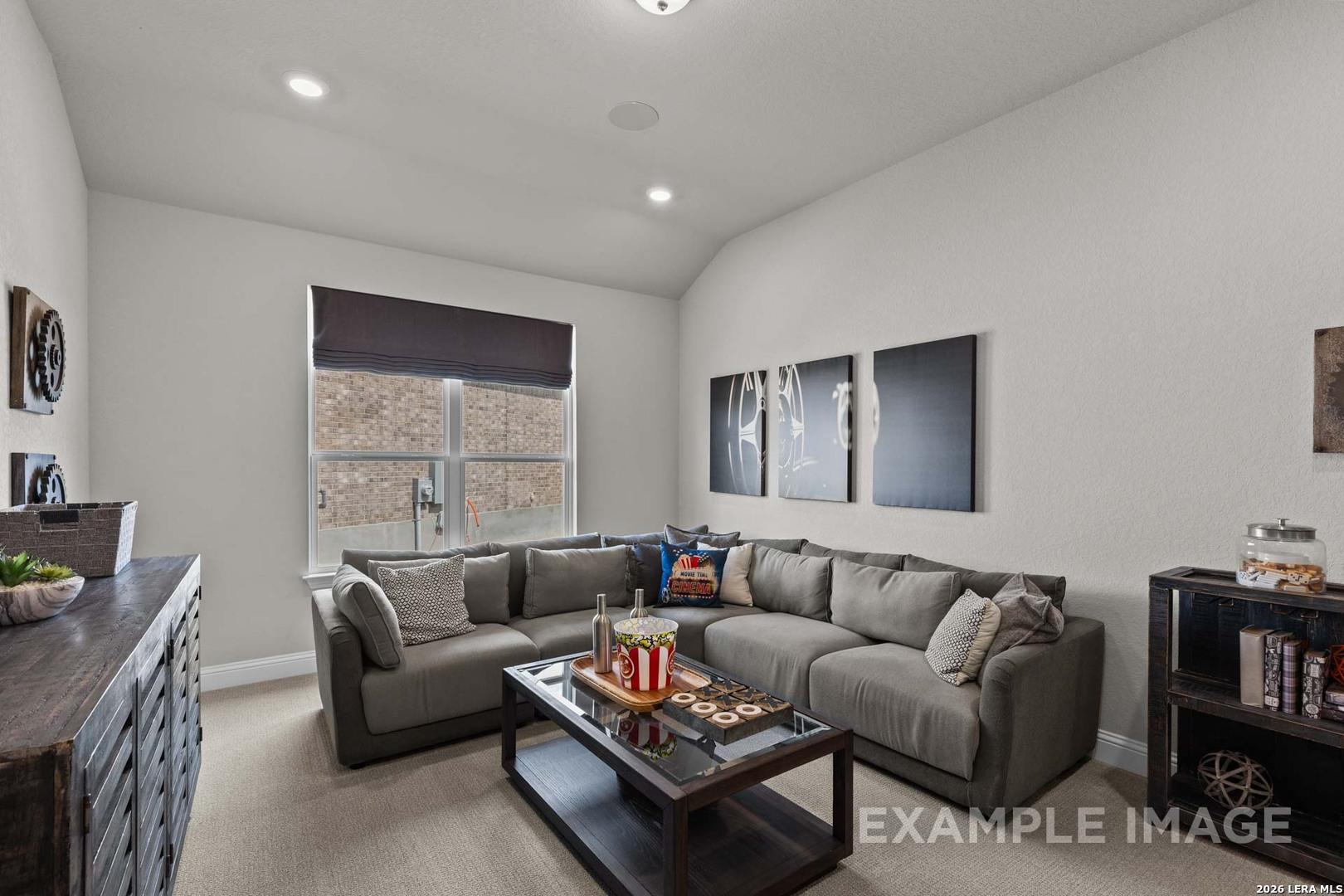 Cozy media room with large grey sectional in The Garner C floor plan by Davidson Homes in The Reserve at Potranco Oaks.