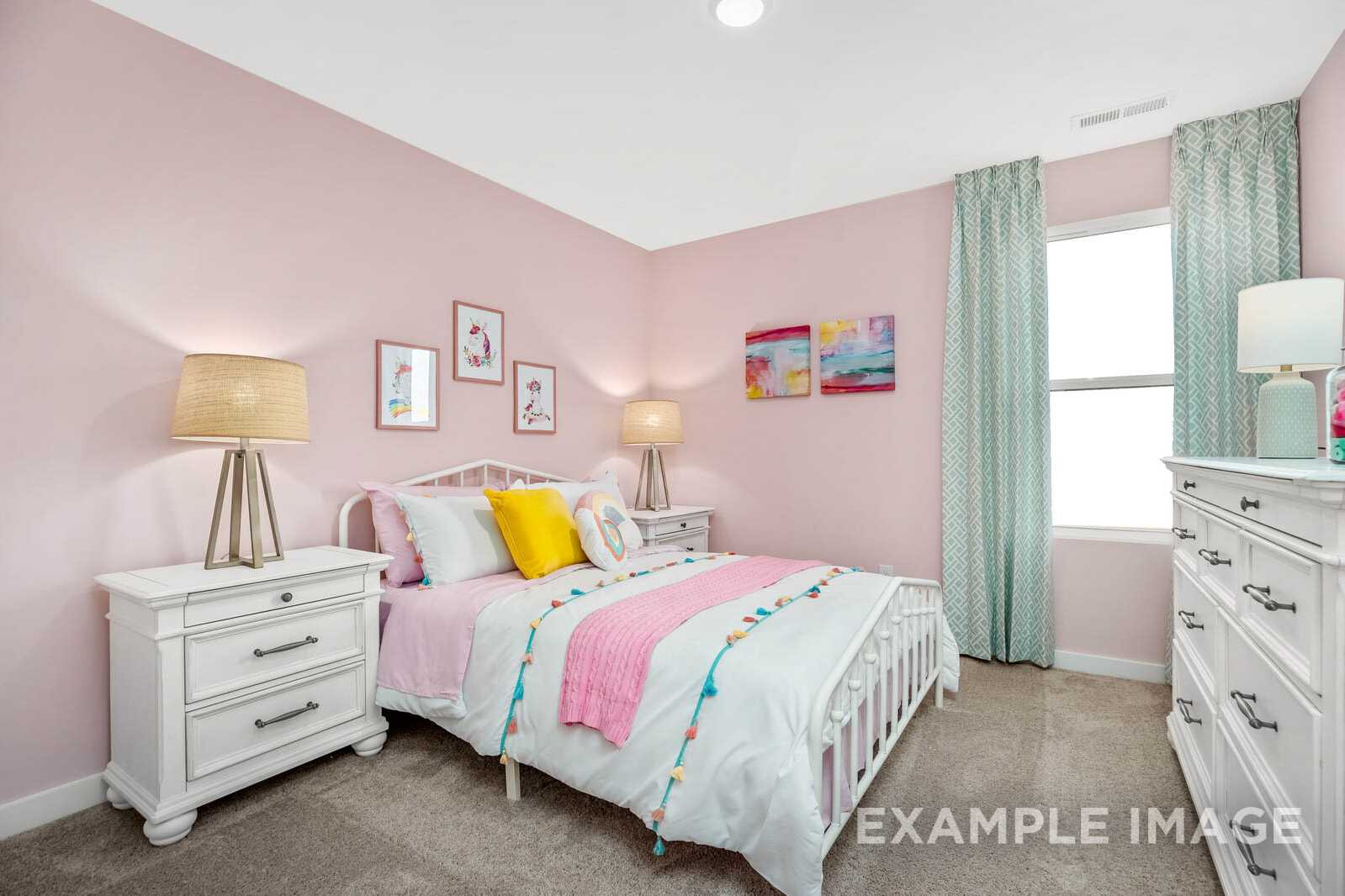 Charming pink girl's bedroom in The Gordon B by Davidson Homes, featuring twin bed, white furniture, lamps, and artwork