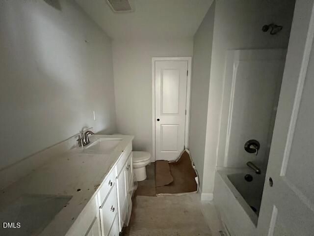 Spacious bathroom featuring double vanity, bathtub, shower, and toilet in Davidson Homes The Adalynn B, Lillington, NC