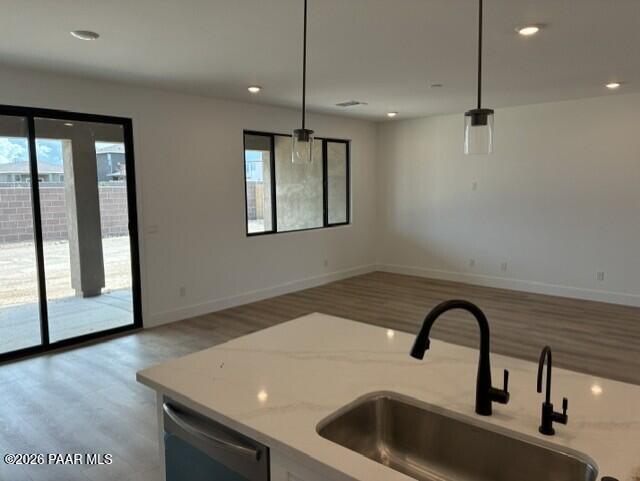Open-concept kitchen island with matte black faucet and sliding glass door to backyard in Davidson Homes Durango II, Prescott AZ