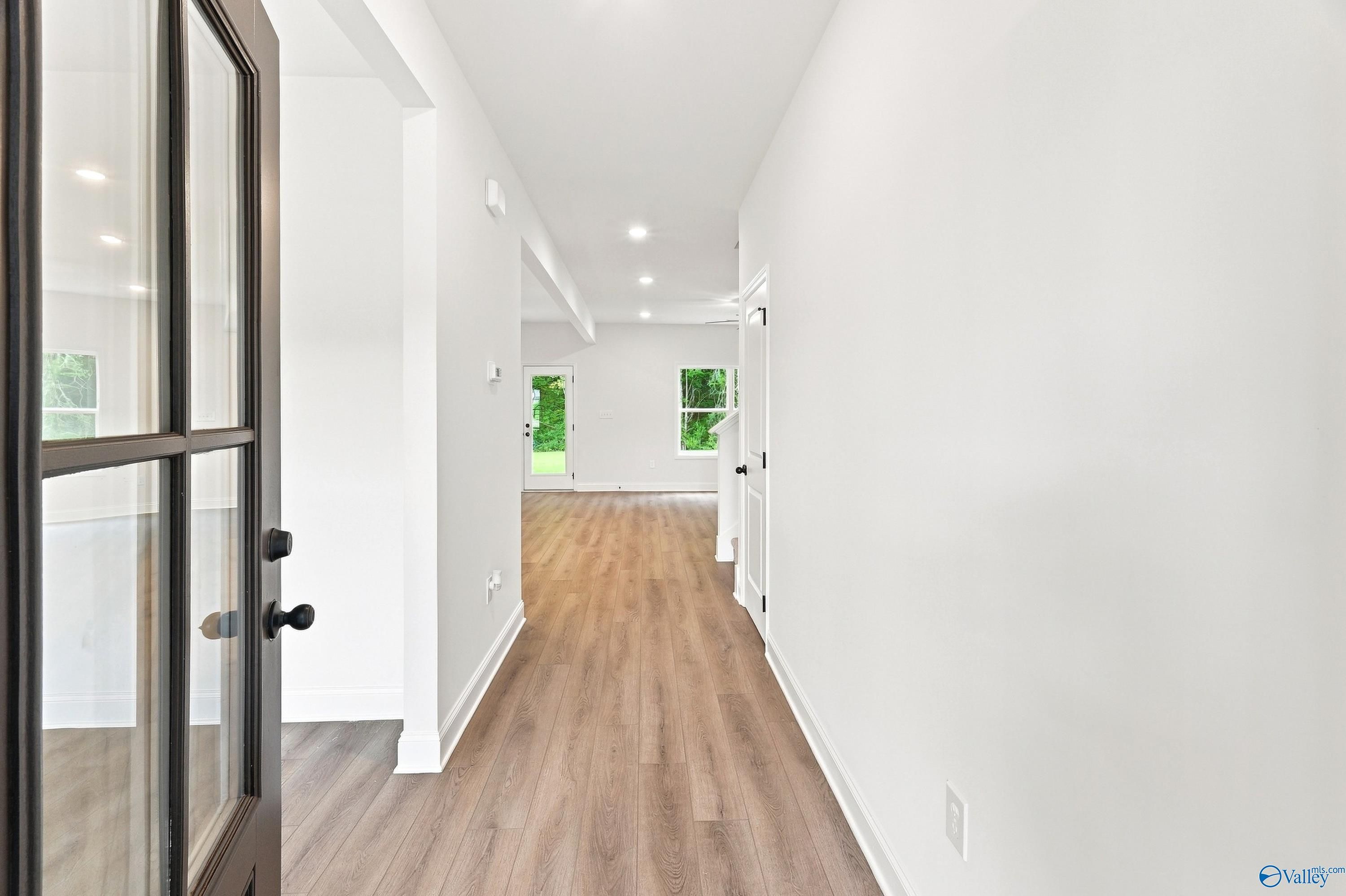 Bright entryway with wood-style flooring in The Shelby B floor plan at Jaguar Hills, Huntsville, Alabama.