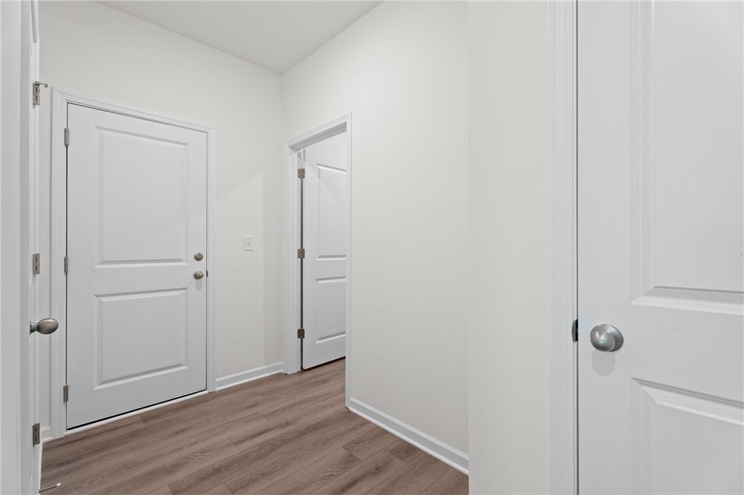 Bright entryway with wood-style flooring in The Stella D floor plan by Evermore Homes in Silver Oak, Cusseta, Alabama.